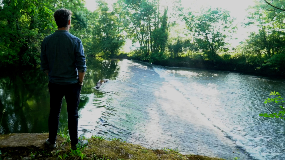 Martin standing by a river