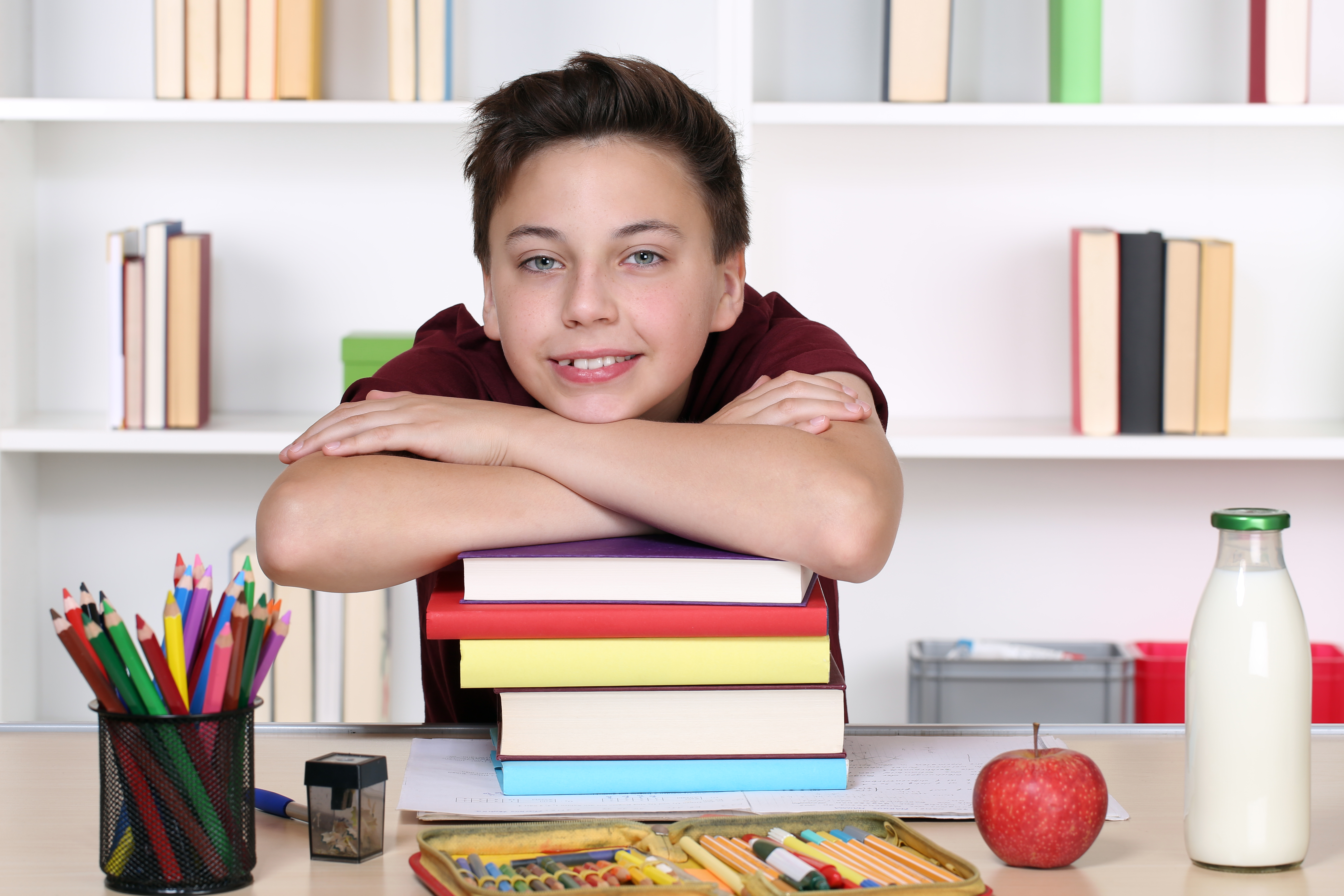 Boy with head on books