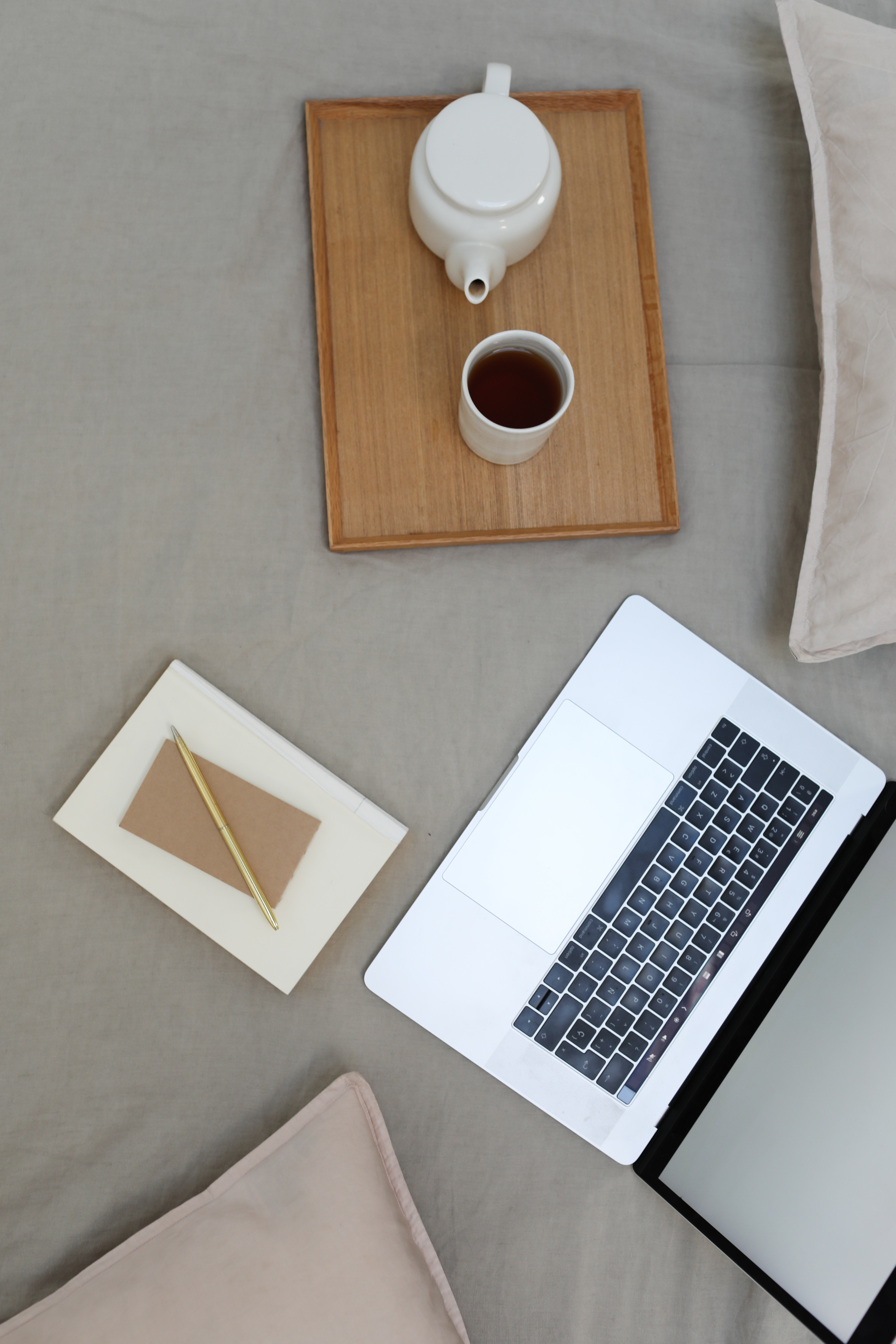 picture of coffee cup on tray and laptop next to it.