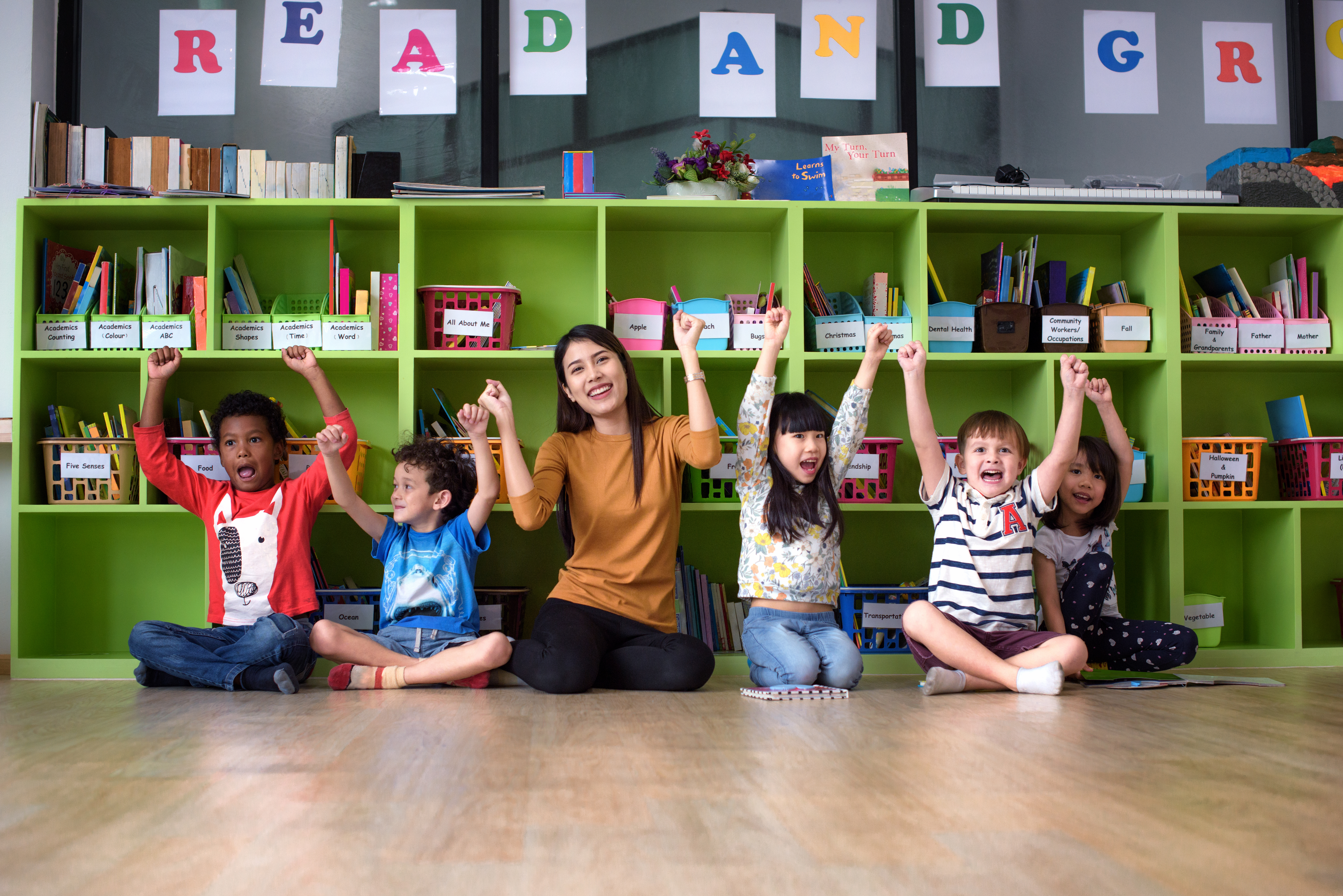 Teacher and students sitting on the floor