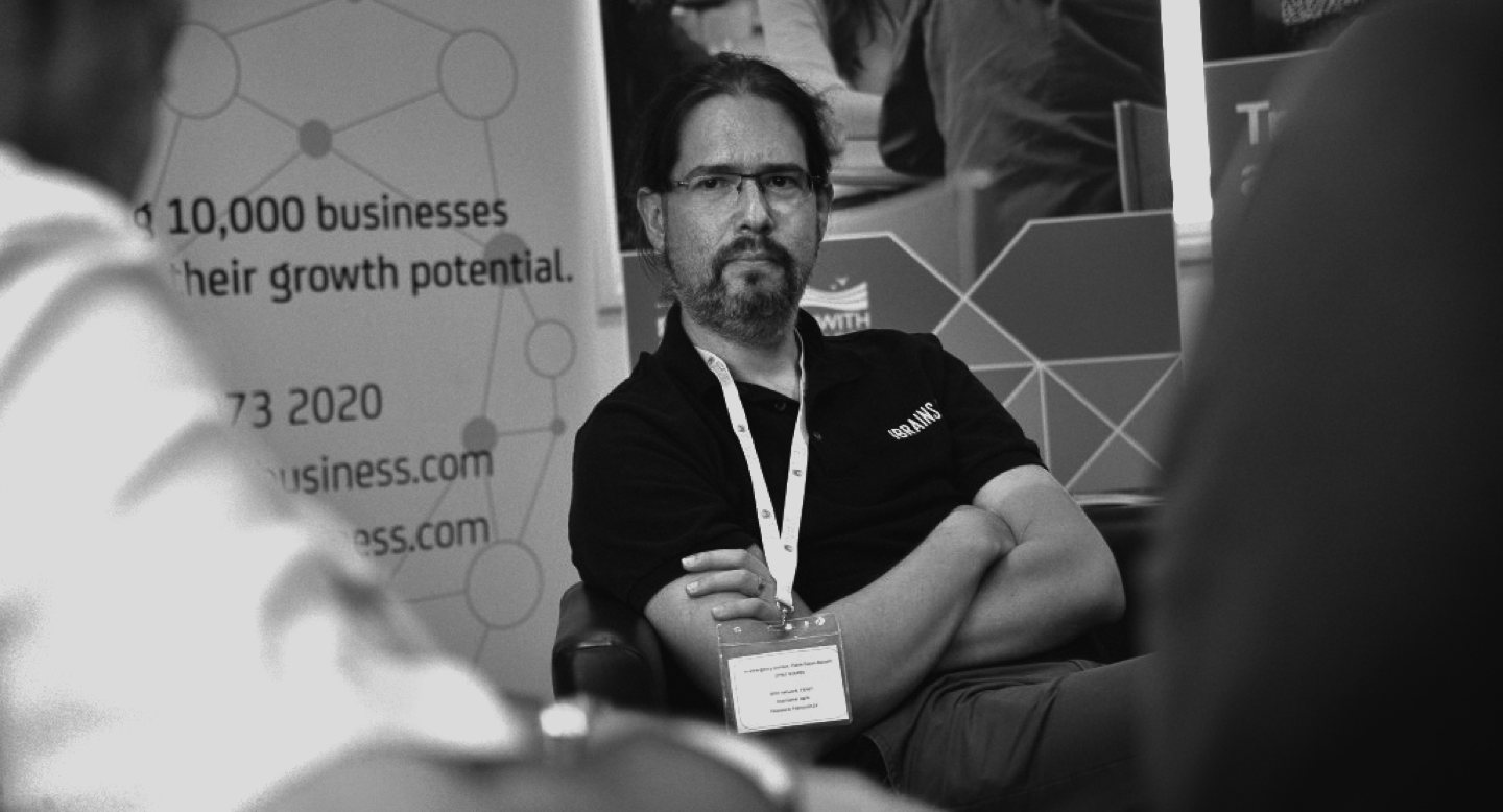 J. B. Rainsberger, listening intently to someone during a chat at a conference.