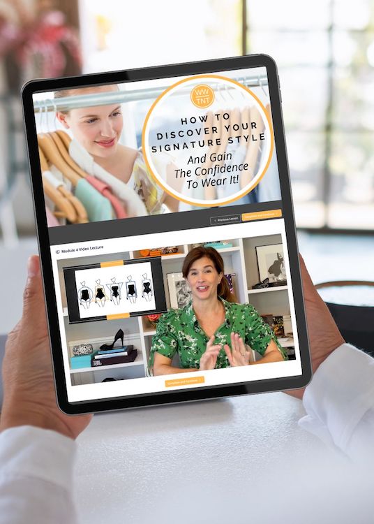 woman holding tablet with course video on its screen