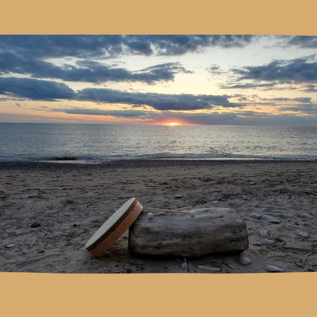 Frame Drum resting on a log at the beach during sunset, symbolizing harmony, nature, and the meditative power of sound healing.  Perfect for relaxation, mindfulness, and sacred music practices.