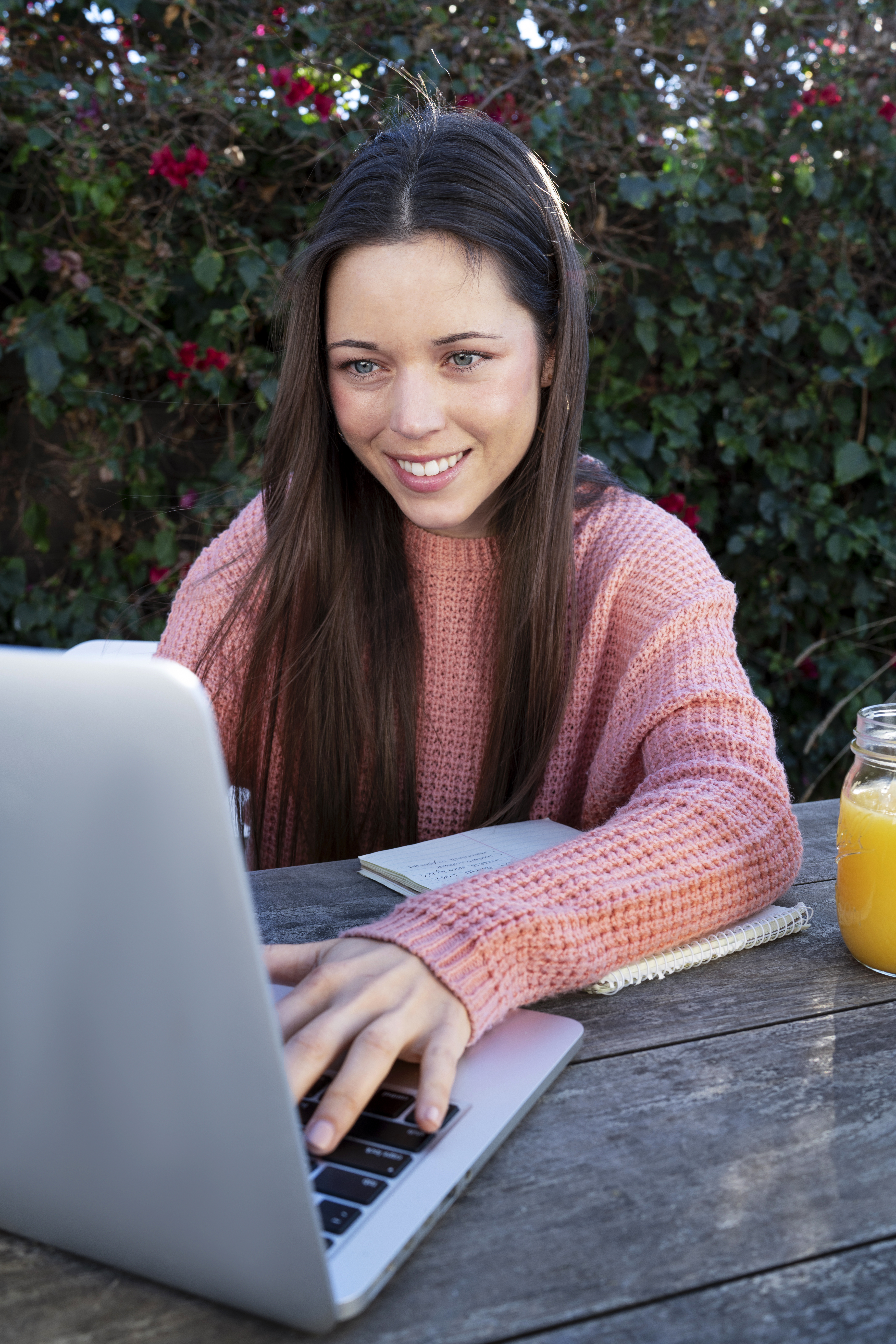 Woman outside taking an online course on laptop