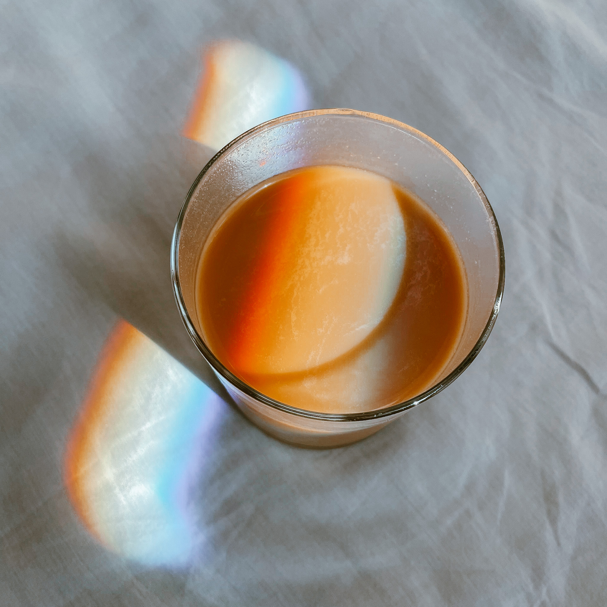 Latte with prismacolor light bouncing across it