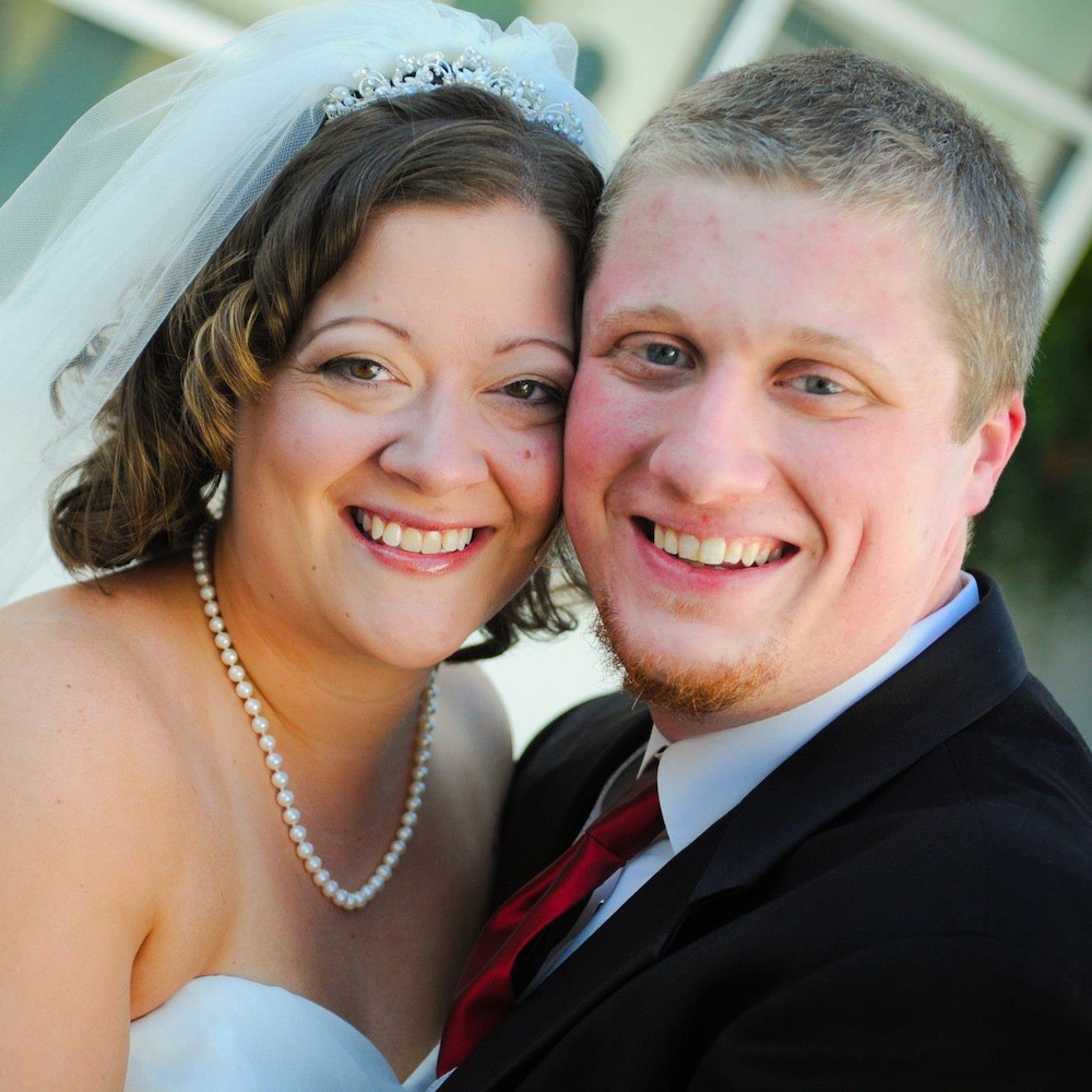 A bride and groom embrace on their wedding day