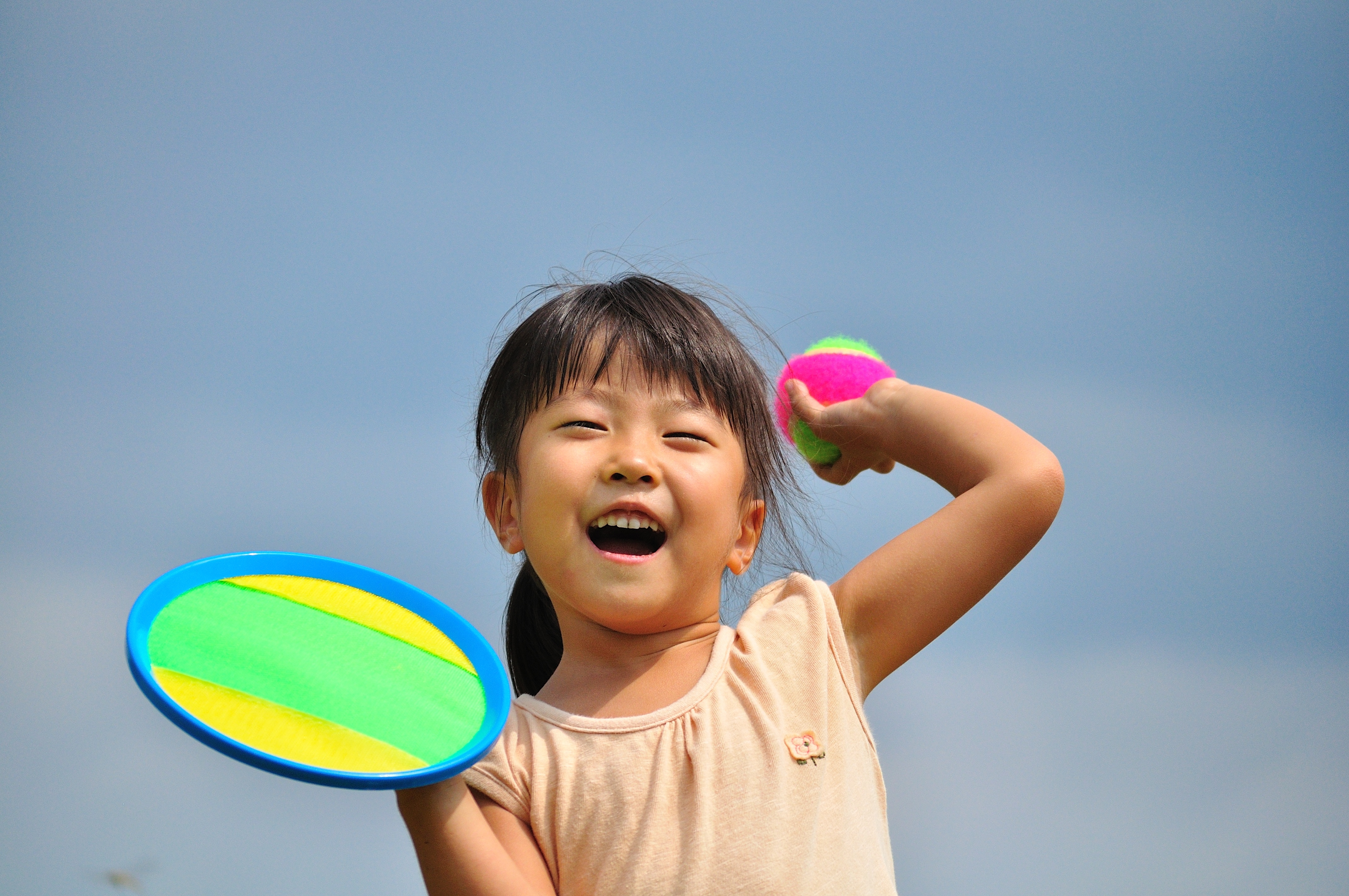 Girl throwing a tennis ball