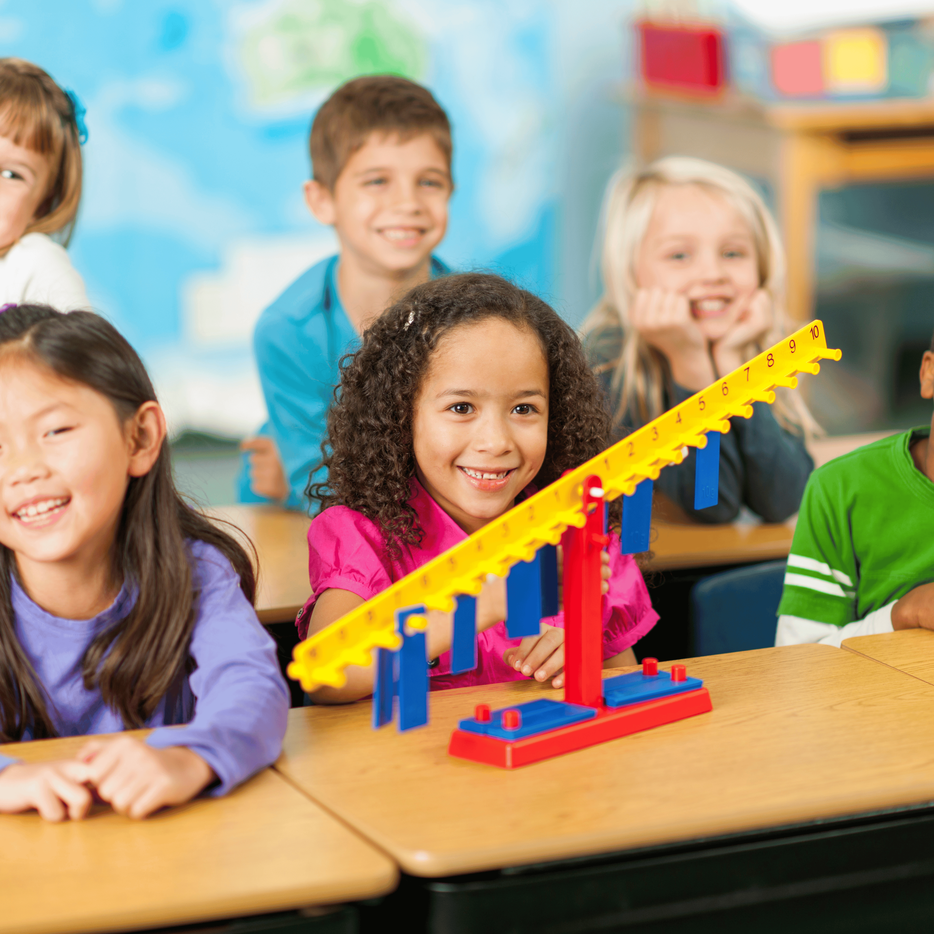 students smiling with math manipulatives