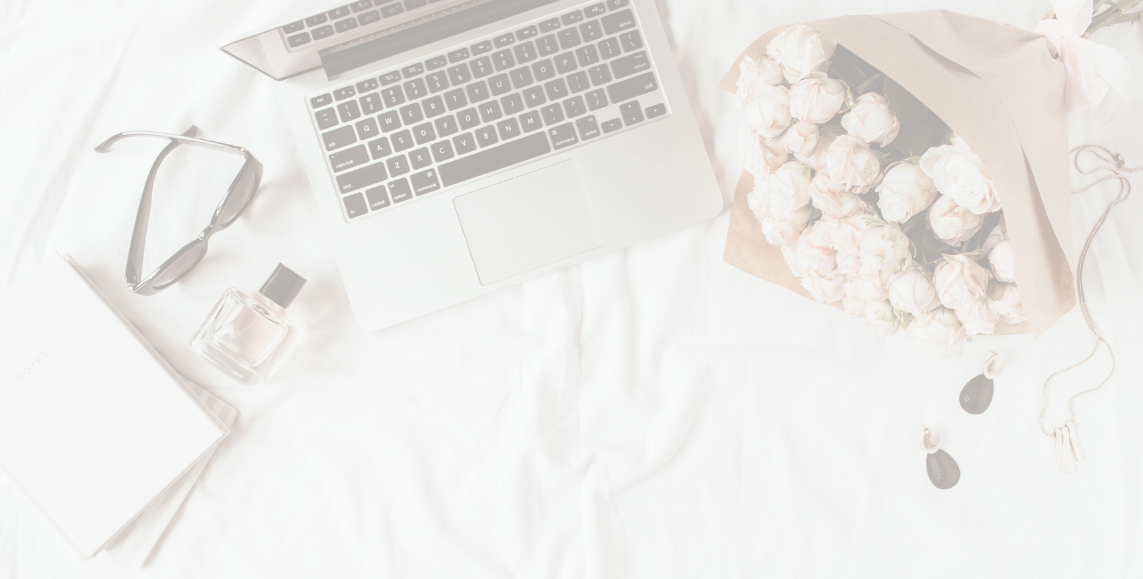 A Feminine laptop flatlay with roses, sunglasses and nail polish