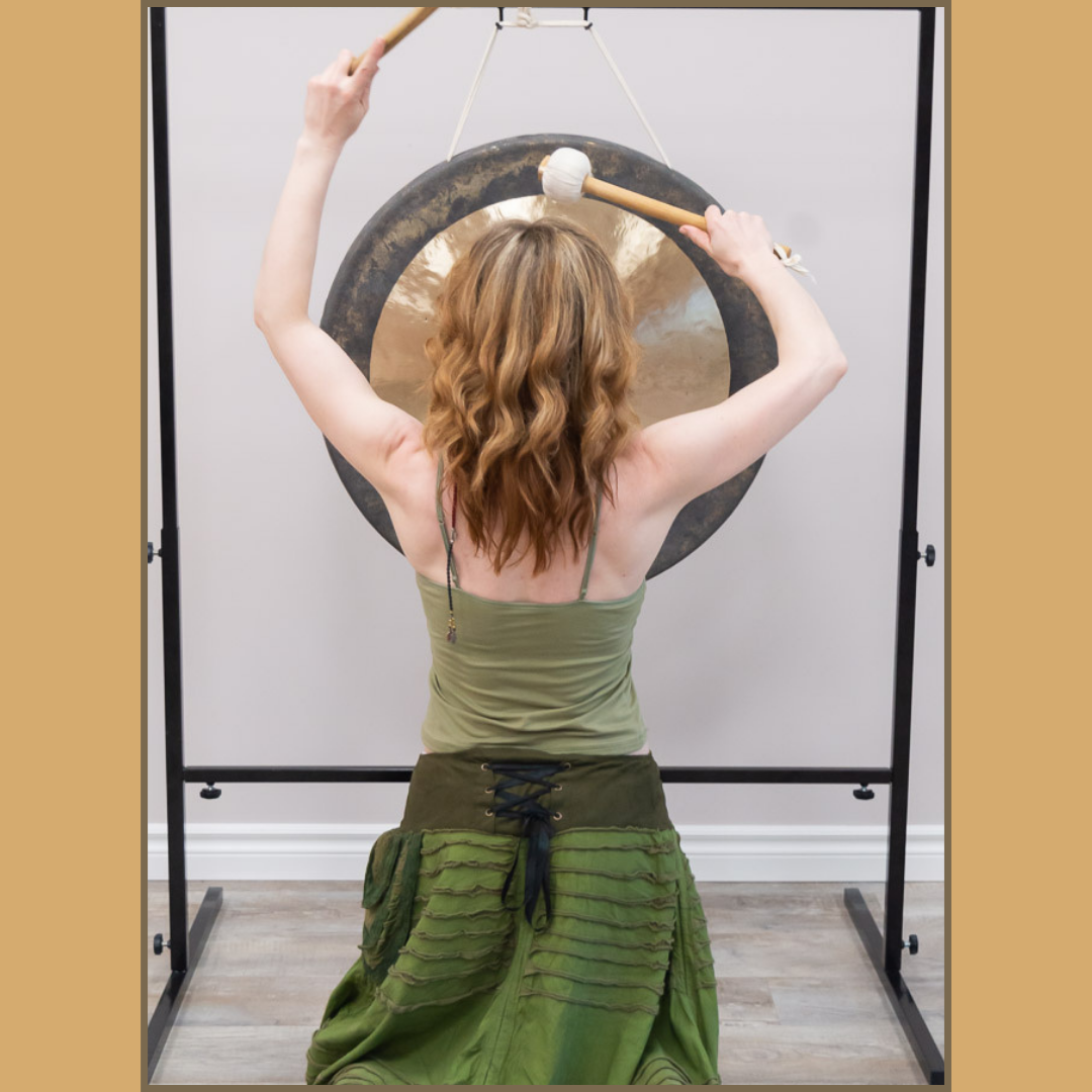 Shannon Rose Scott playing the gongs during a Sound Healing Certification session with Sound Wisdom, showcasing vibrational healing techniques.