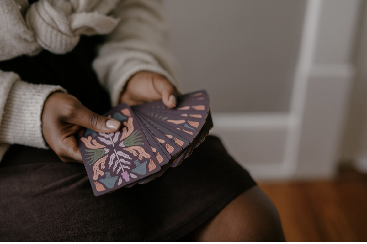 Holding tarot cards