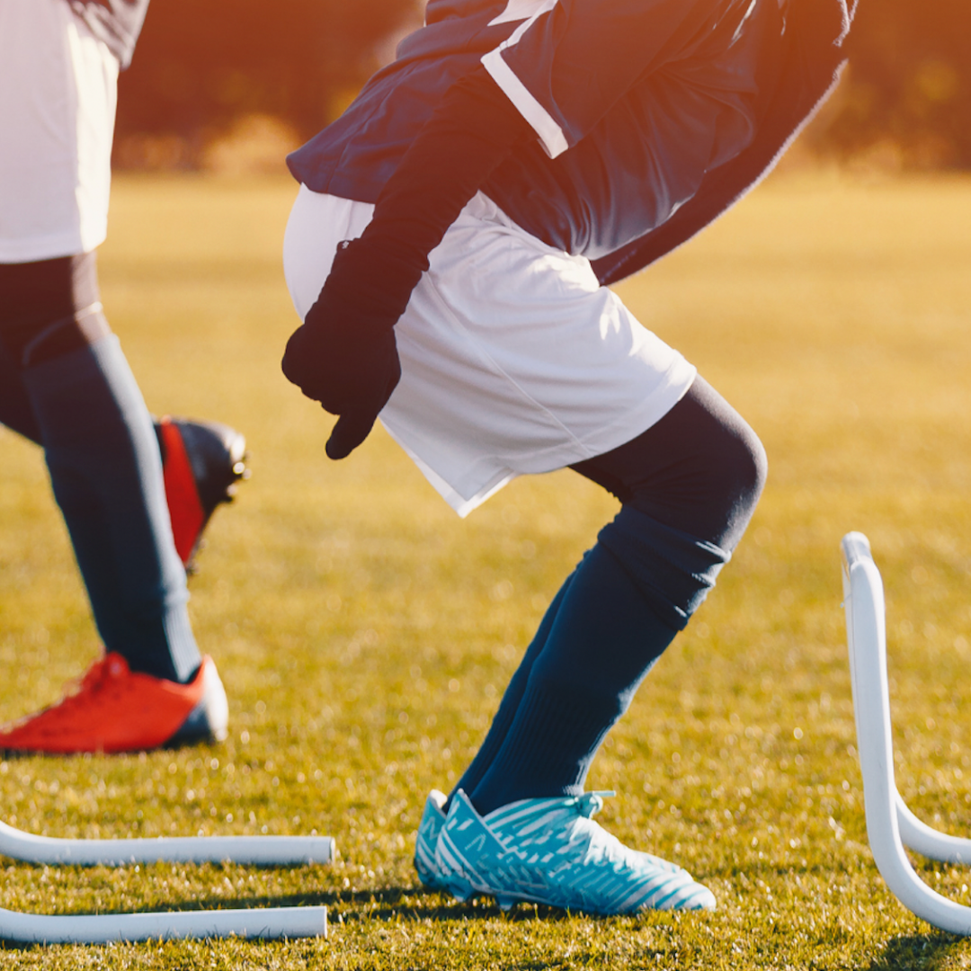 Athletes performing exercises on a grassy field.