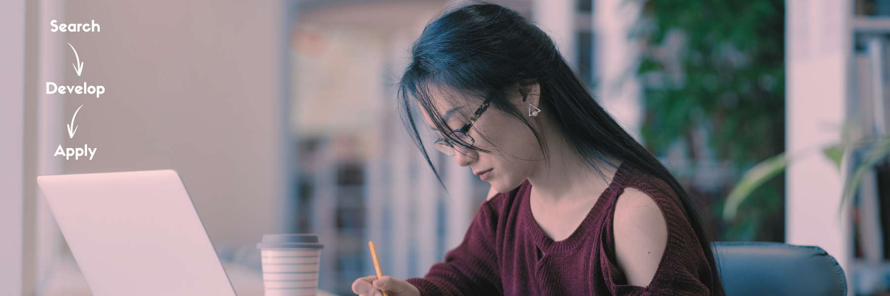 A woman writing a fellowship in a library