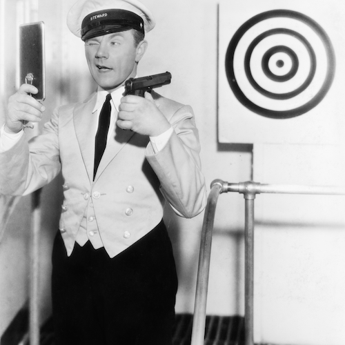 comedy image of ship steward attempting to hit a target using a mirror to fire gun over shoulder