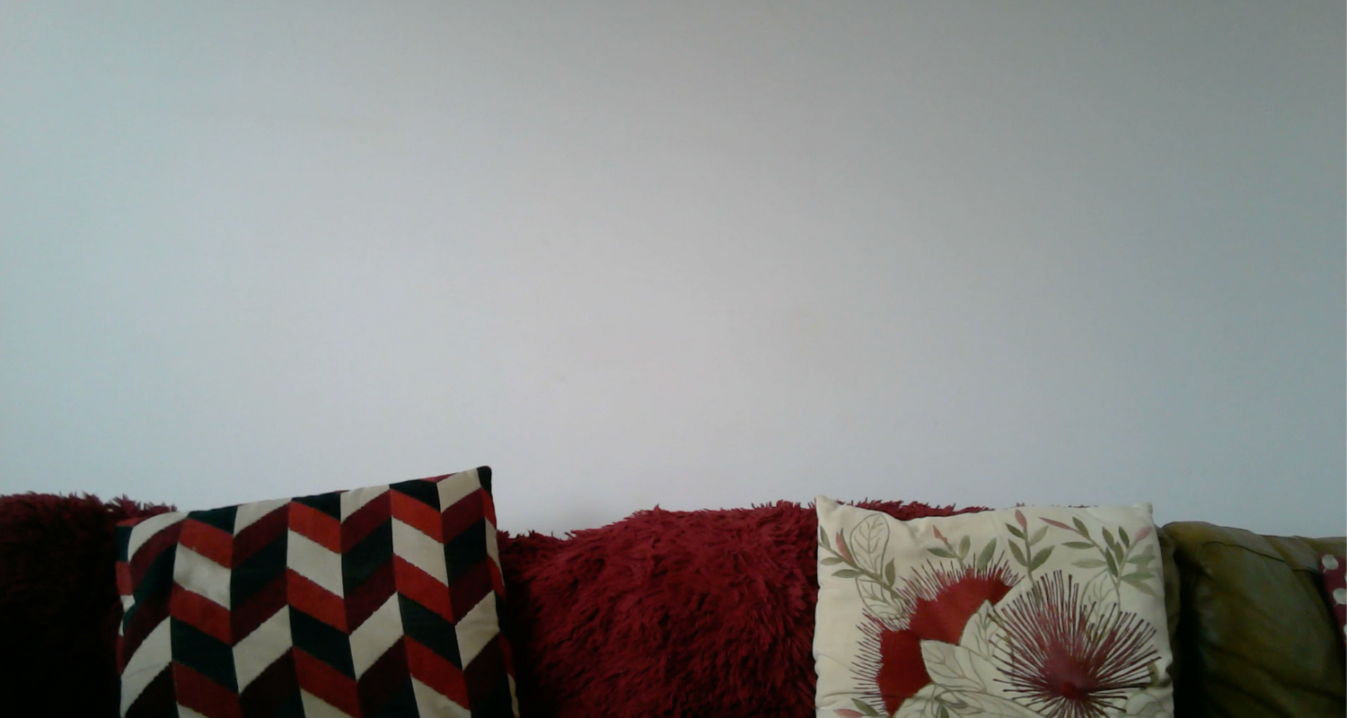 Top part of a couch with different coloured cushions