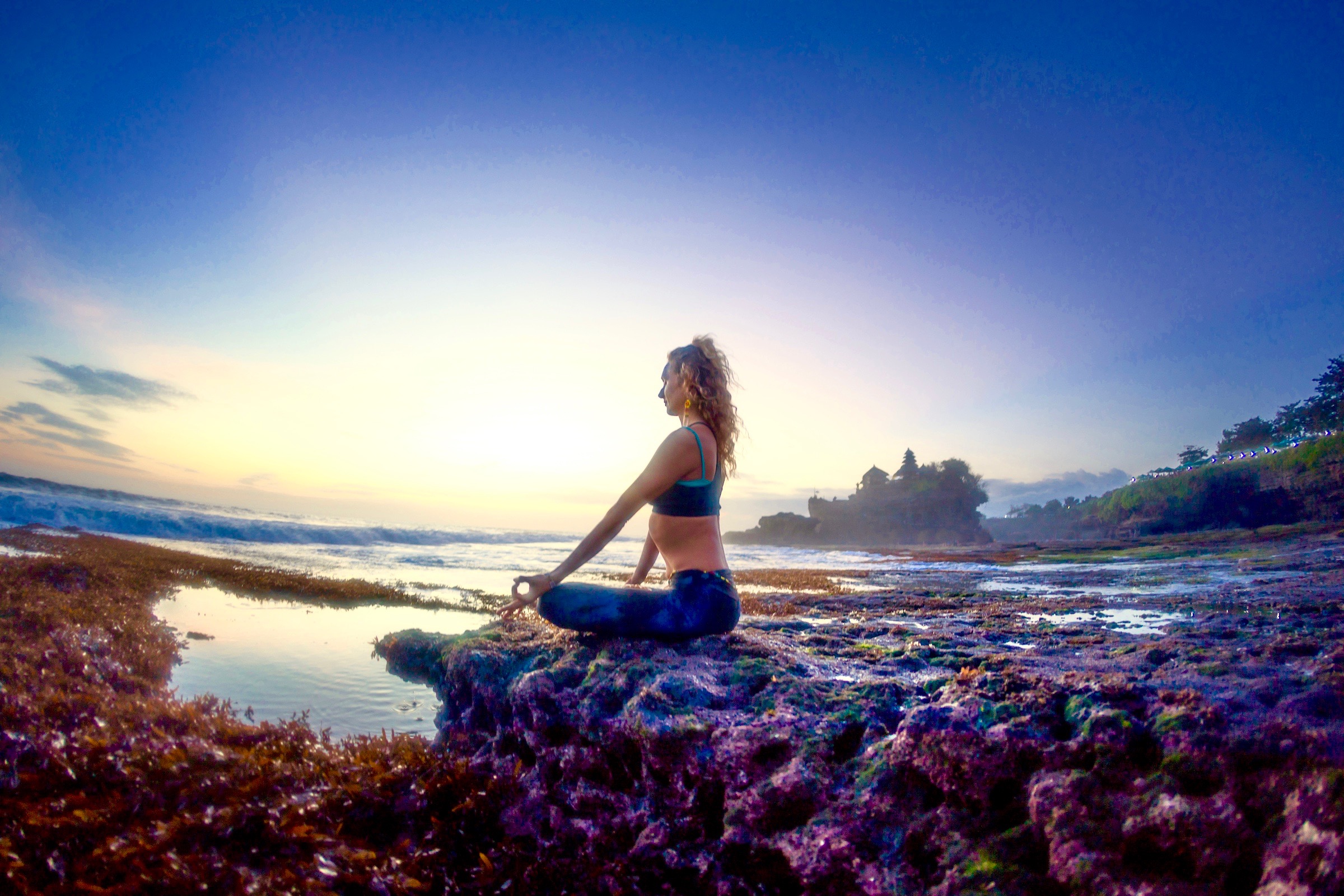 Yoga teacher Bex Tyrer in backbend by the sea in Bali