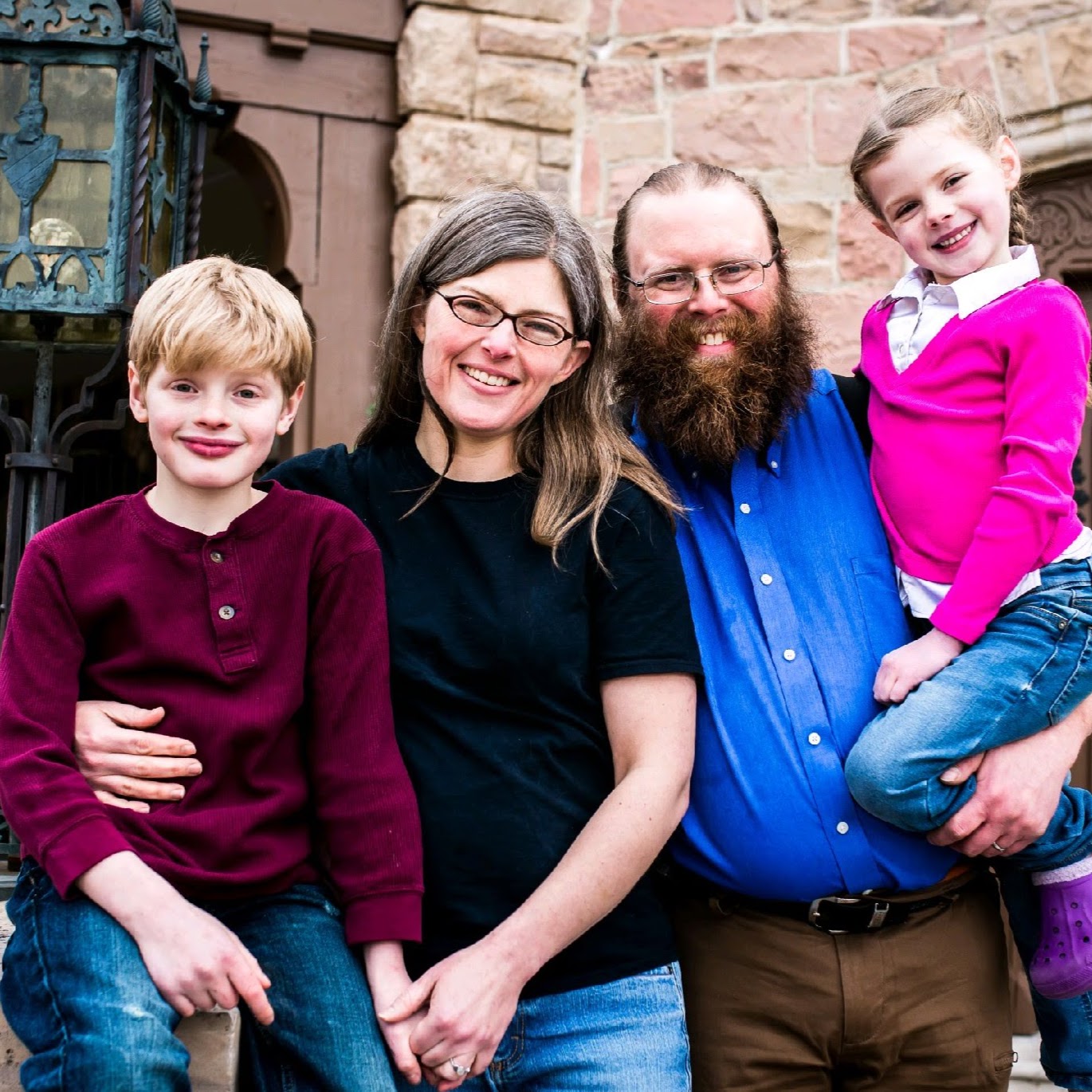 Dr. Robin Dickinson, Tim Dickinson, and their two children in front of a historic building south of Denver