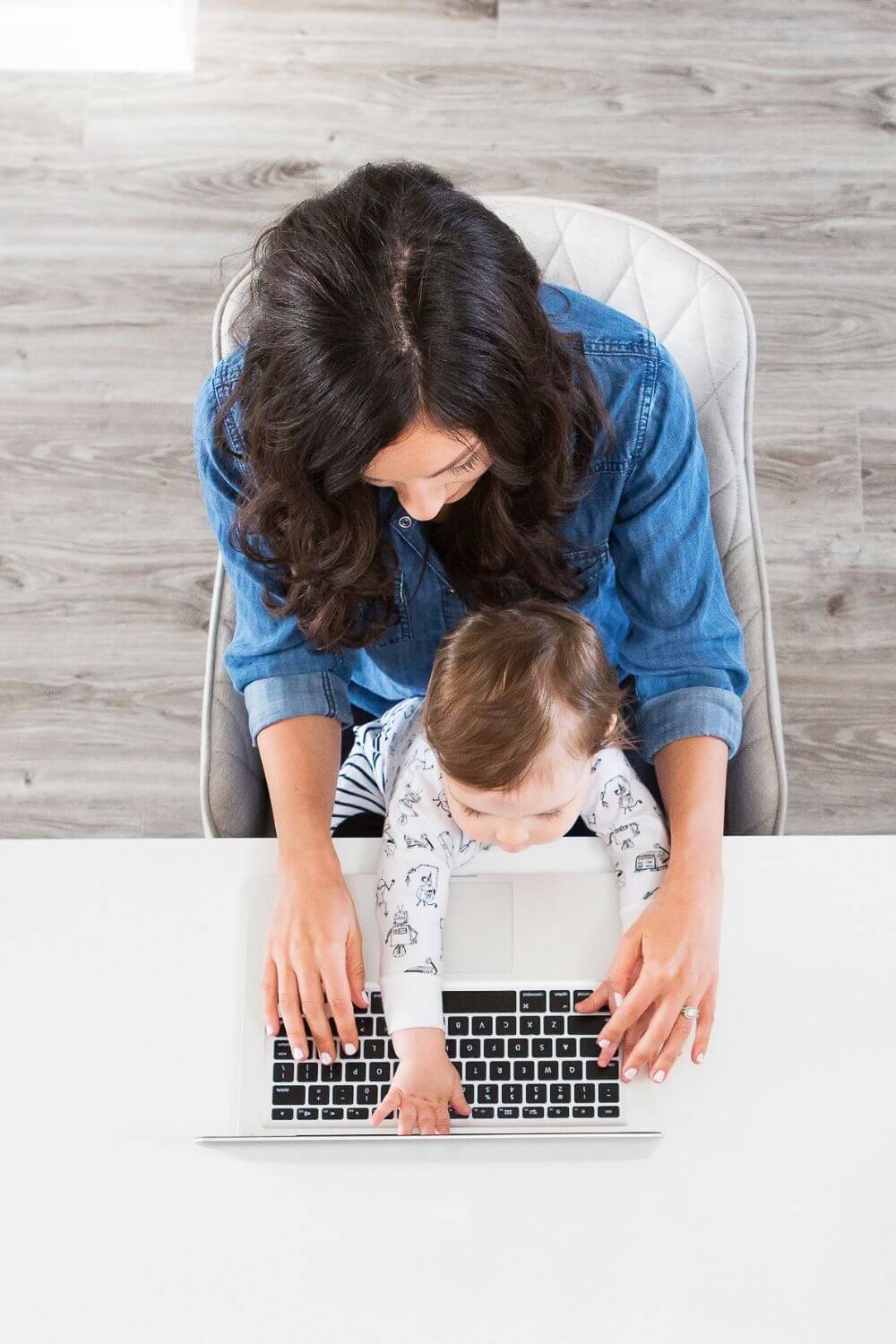 Mom and baby at computer, shot from overhead