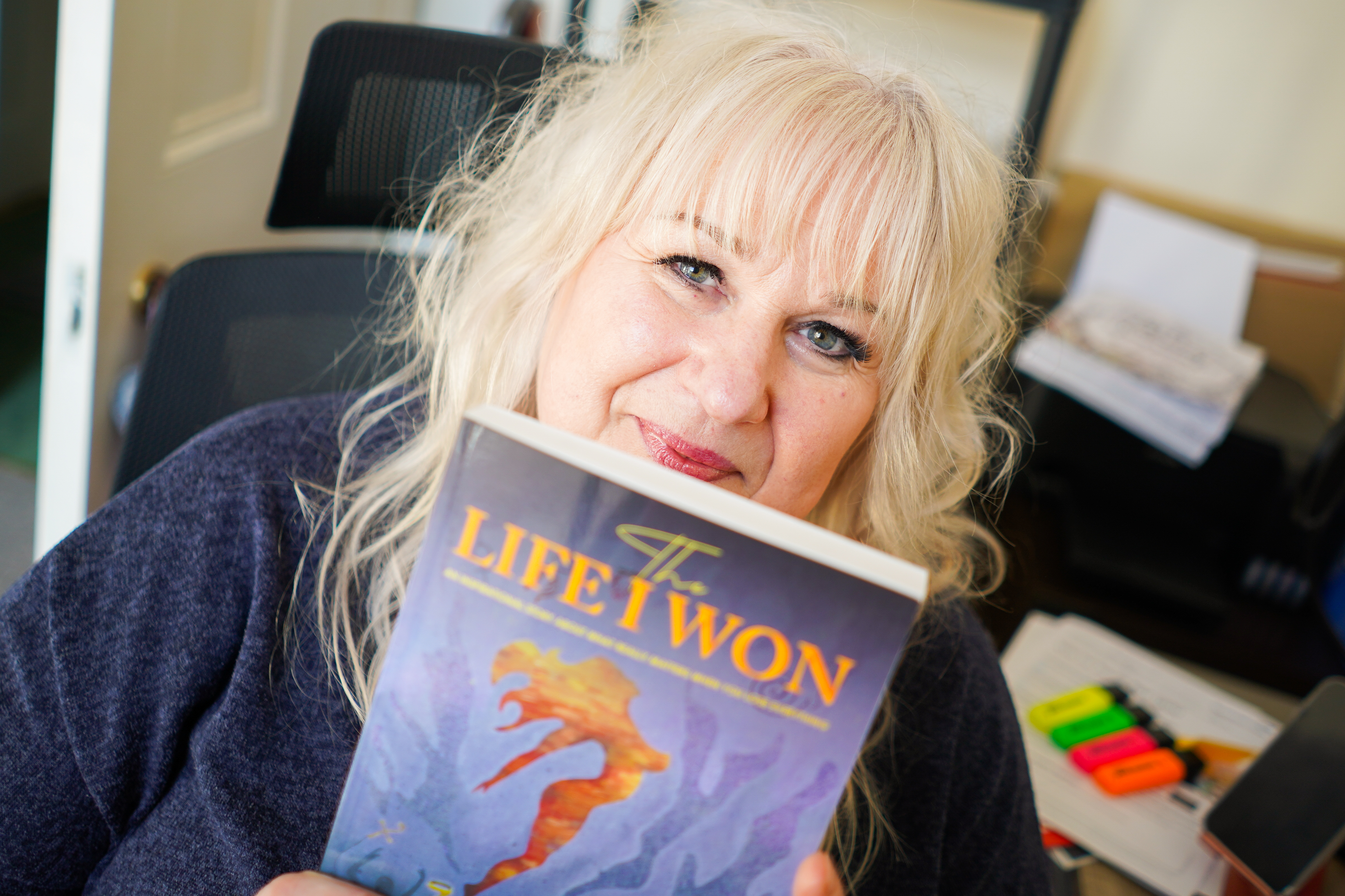 picture of a woman holding up a book