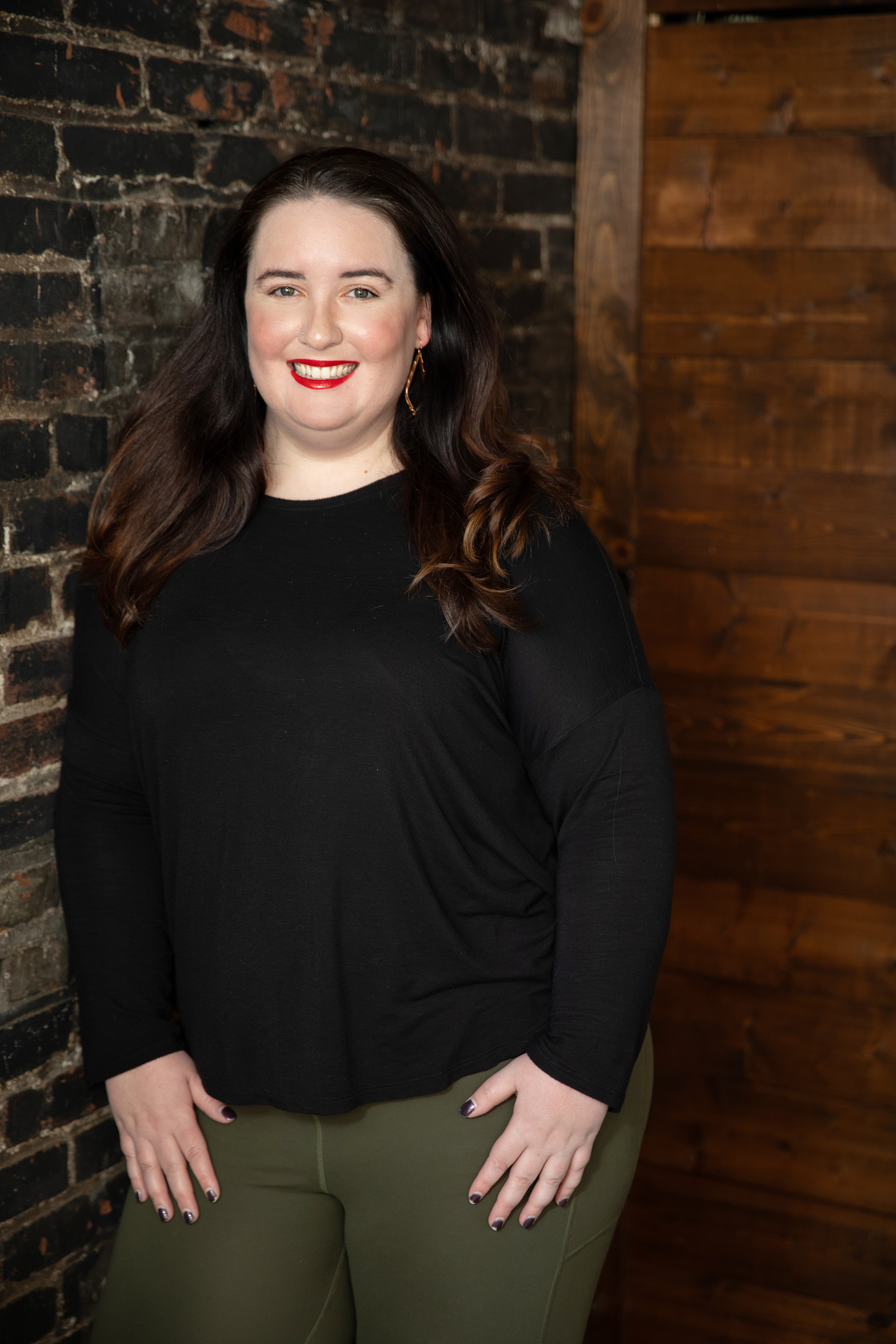 Regan leaning against a brick wall