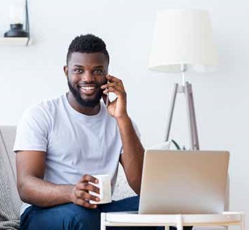 man with mobile phone, cup of coffee and laptop