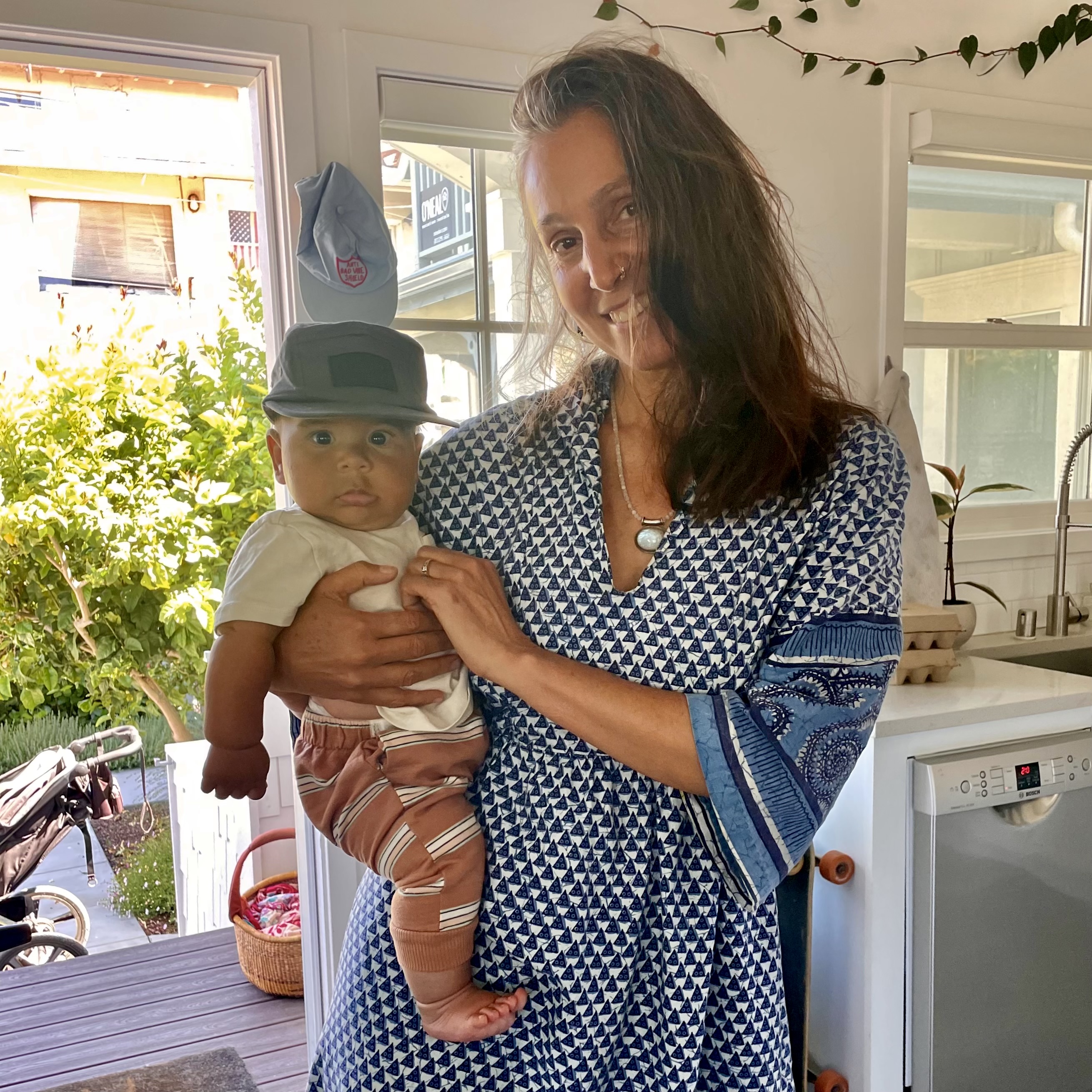 Revital doula care with baby in kitchen