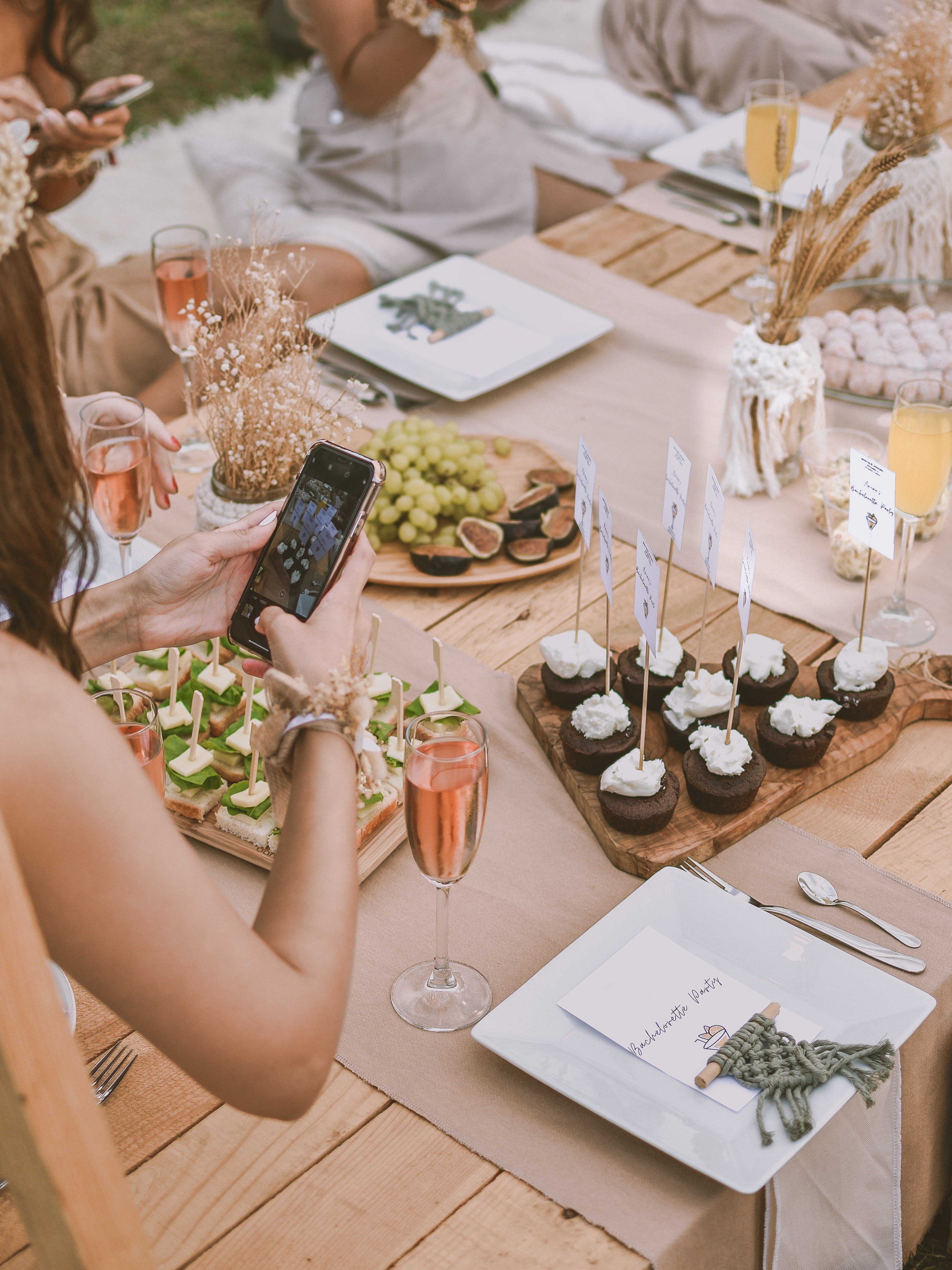 Photo of someone taking photo of food at a table