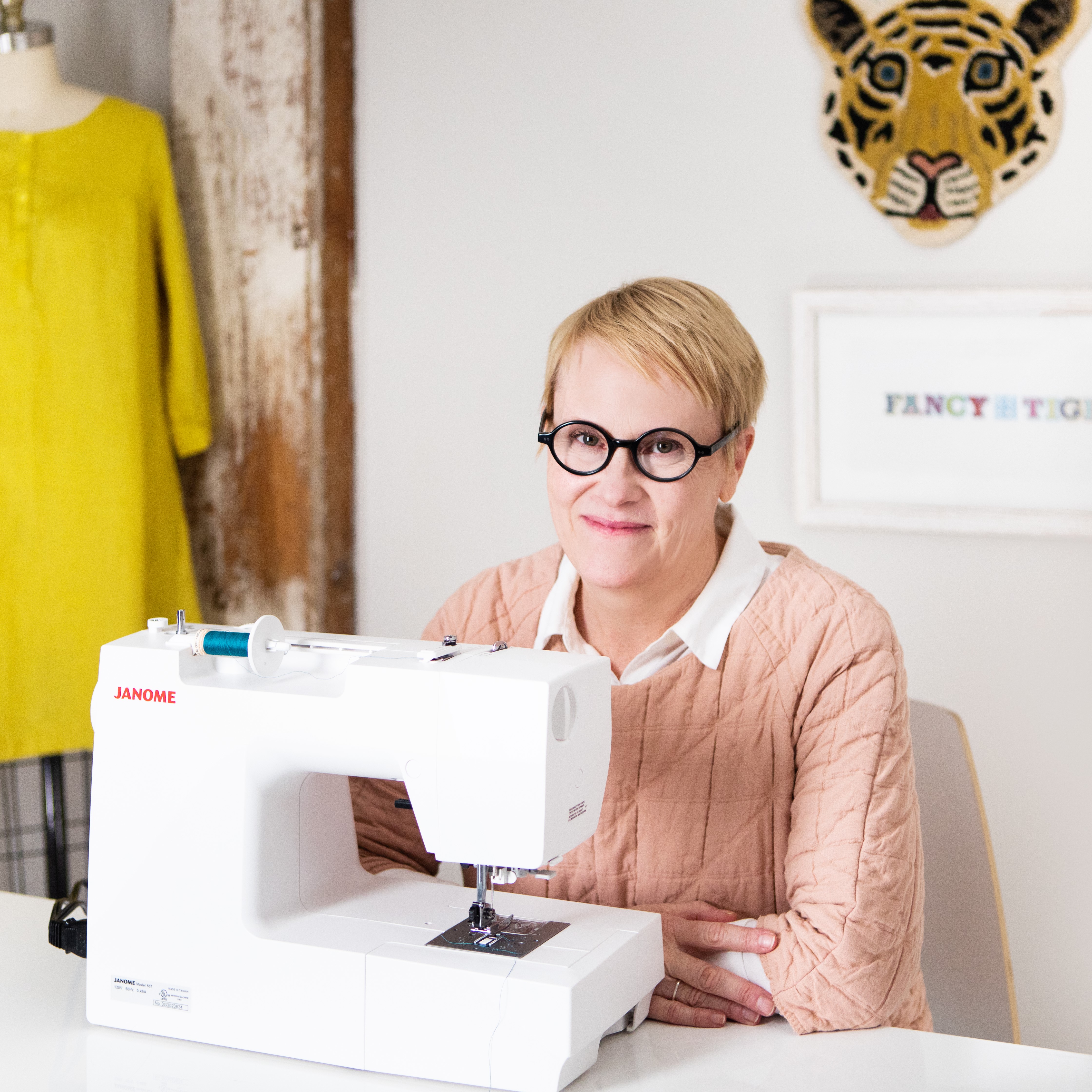 A photo of Christina behind a sewing machine