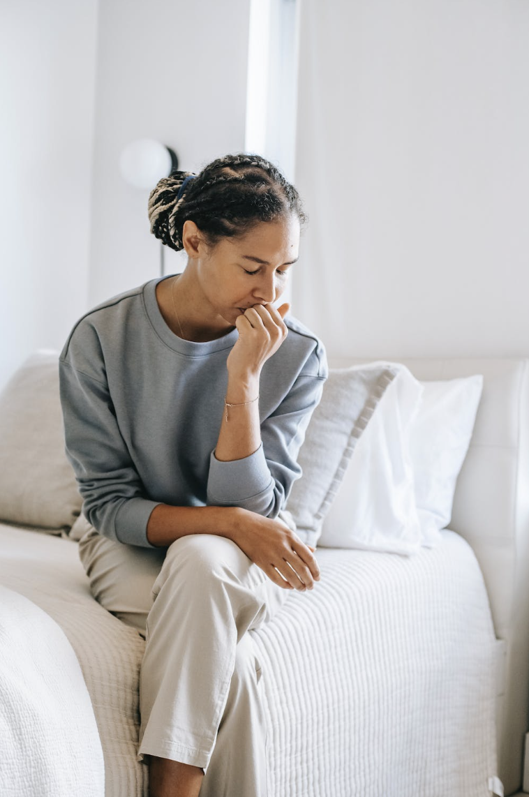 woman in emotional distress, sitting, reflecting 