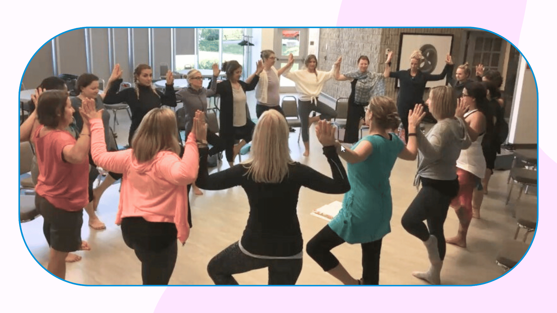 A group of 18 people stand smiling and holding their graduation certificates for the kids yoga teacher training