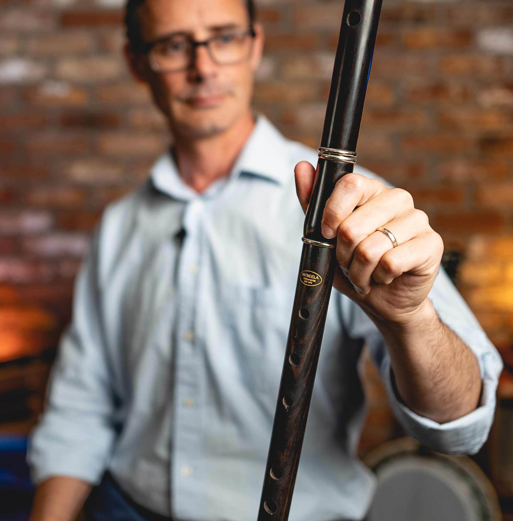 Tom Doorely holds an Irish flute aloft