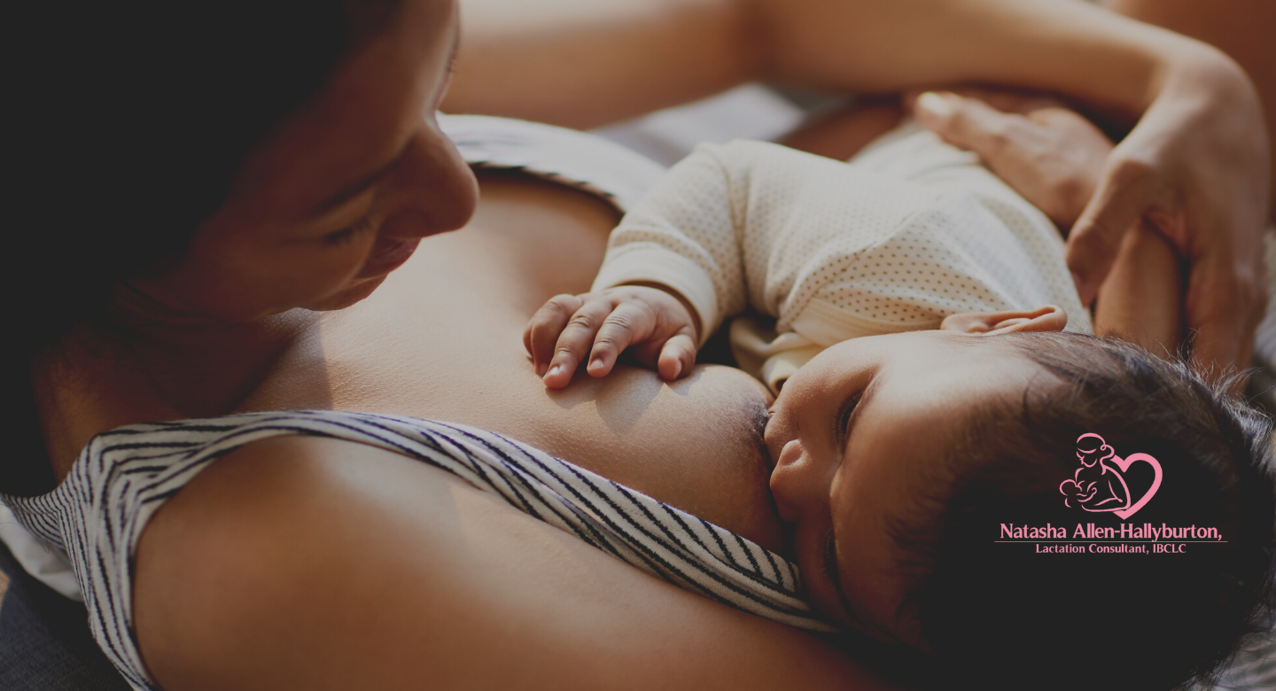 Close up image of a woman reclining while breastfeeding her baby.