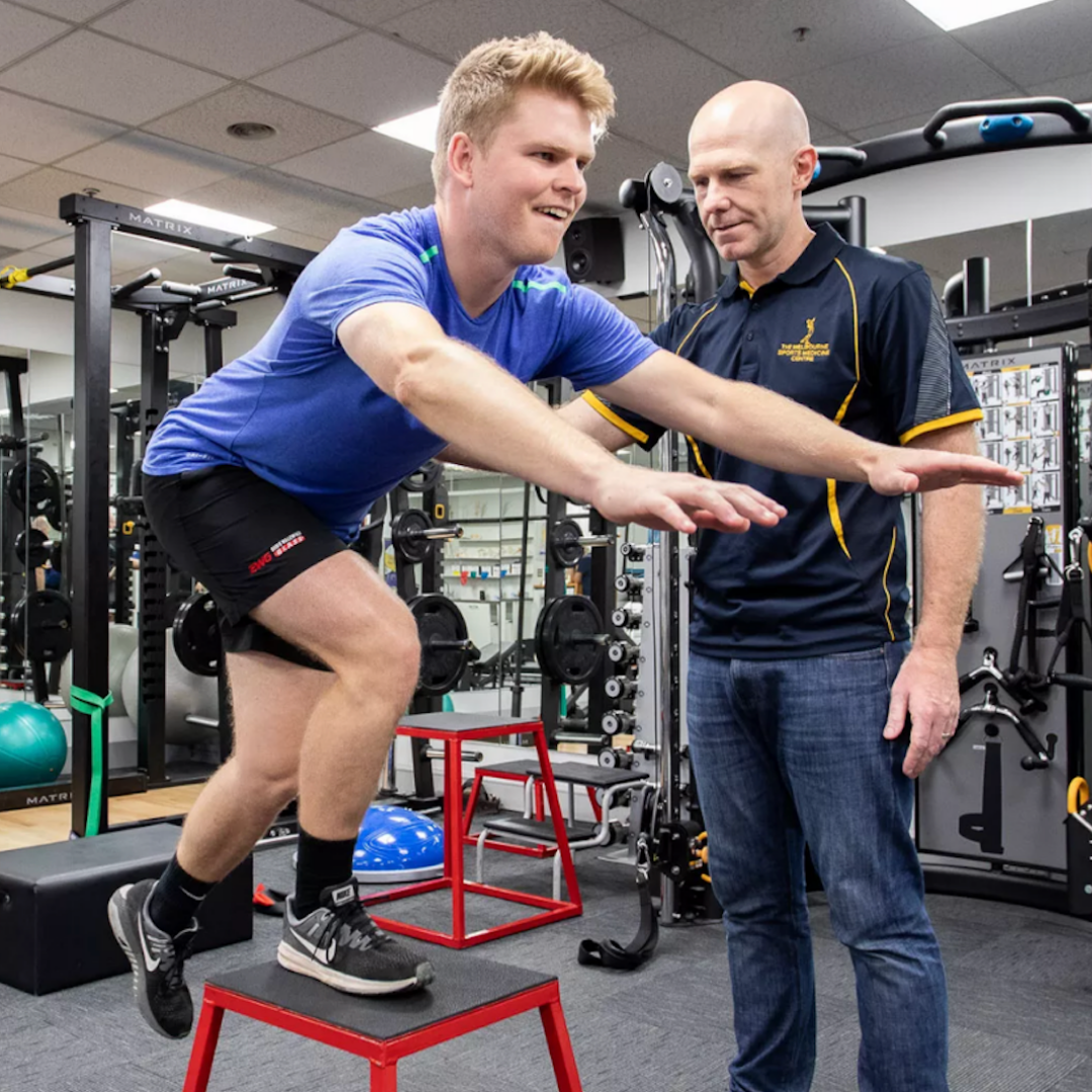 Mick Hughes supervising an ACL recovering session in the gym