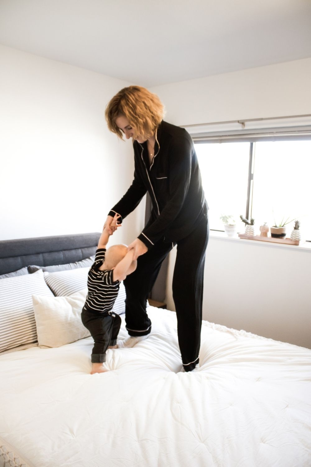 Erin Flynn, jumping on the bed with her toddler