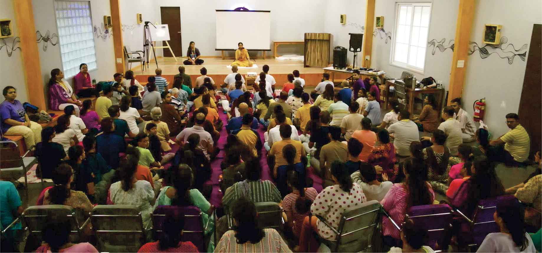 Sadhaks performing Yogasana and Pranayam