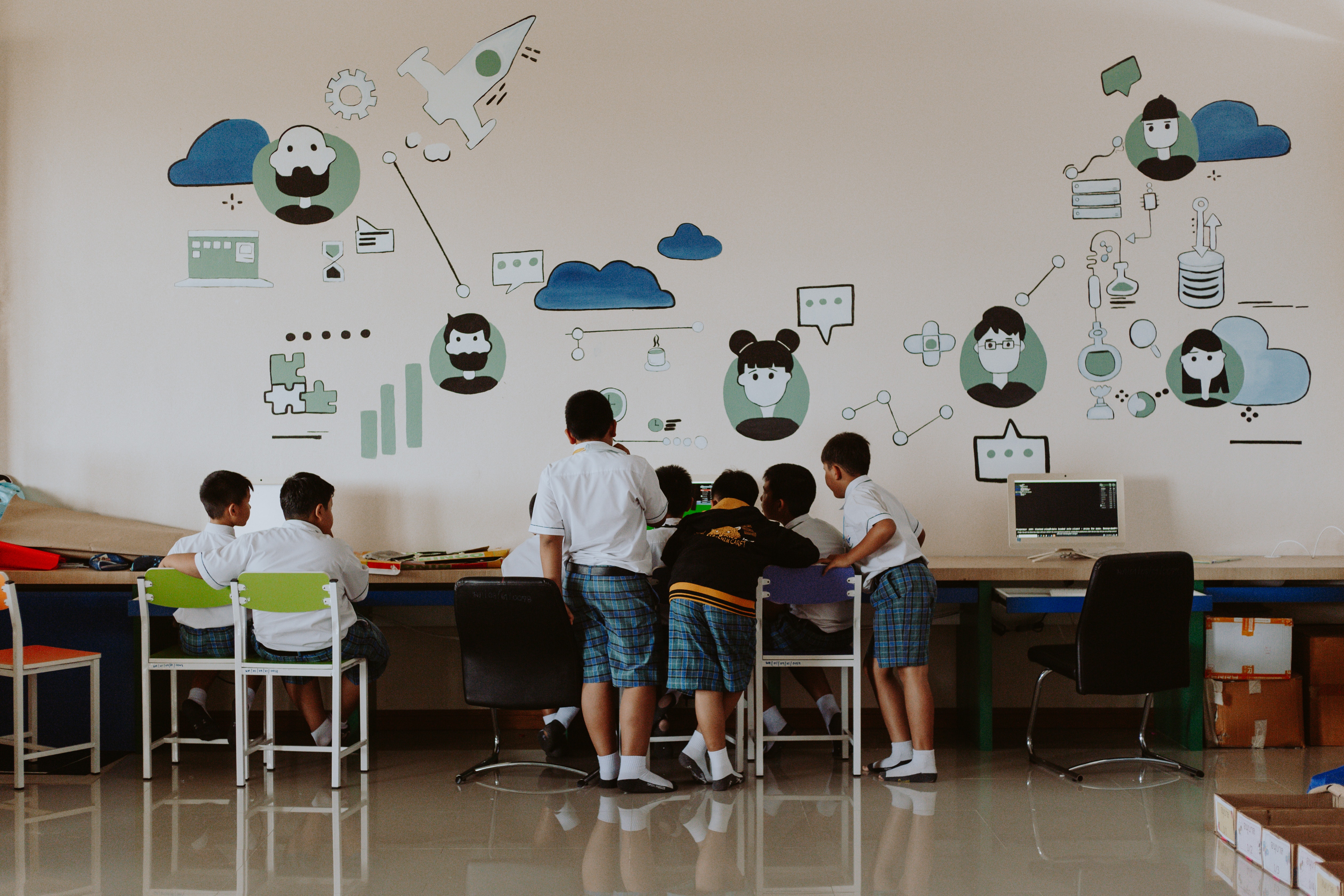 students learning at computers in a technology classroom