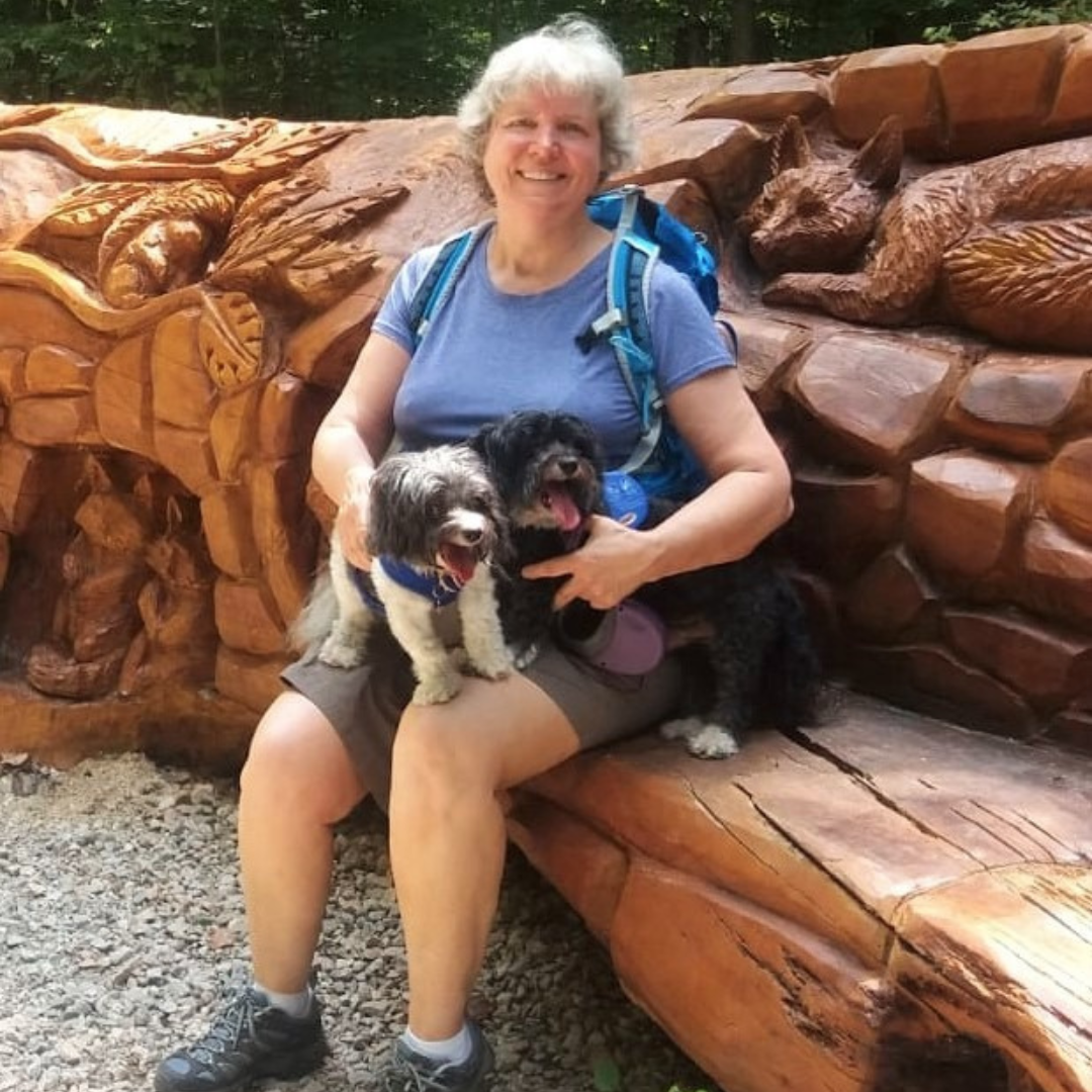 woman hiking with dogs