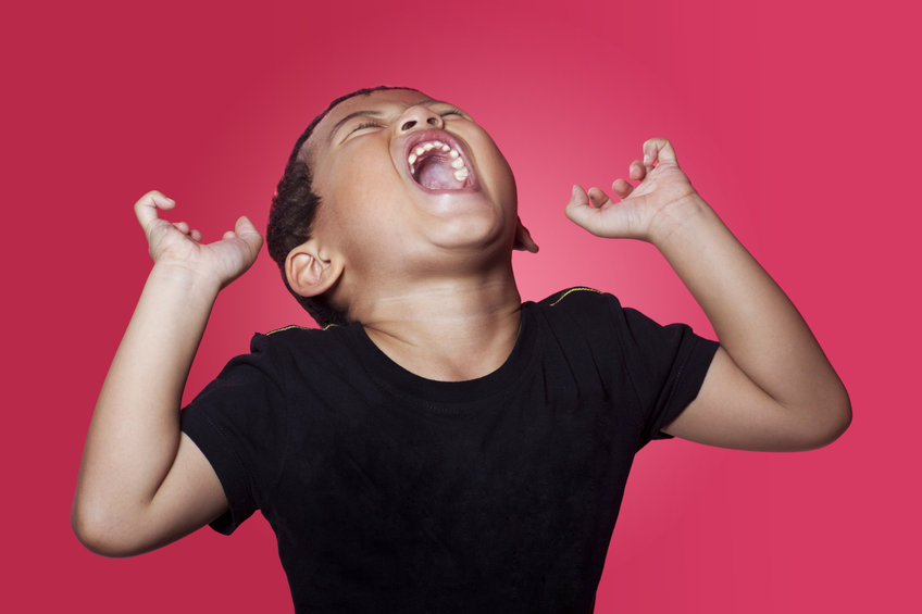 preteen holding her head and screaming