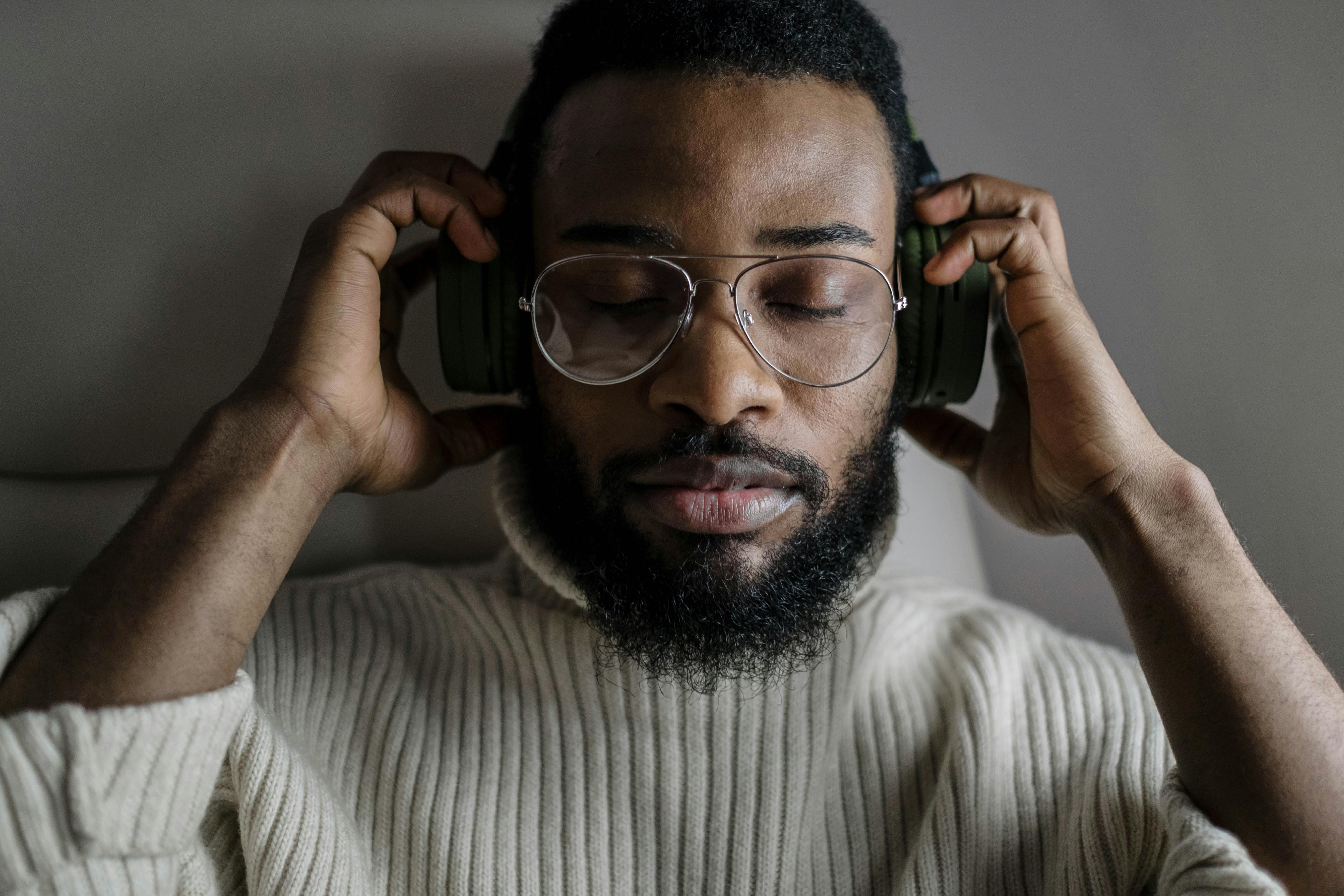 Black man holding earphones