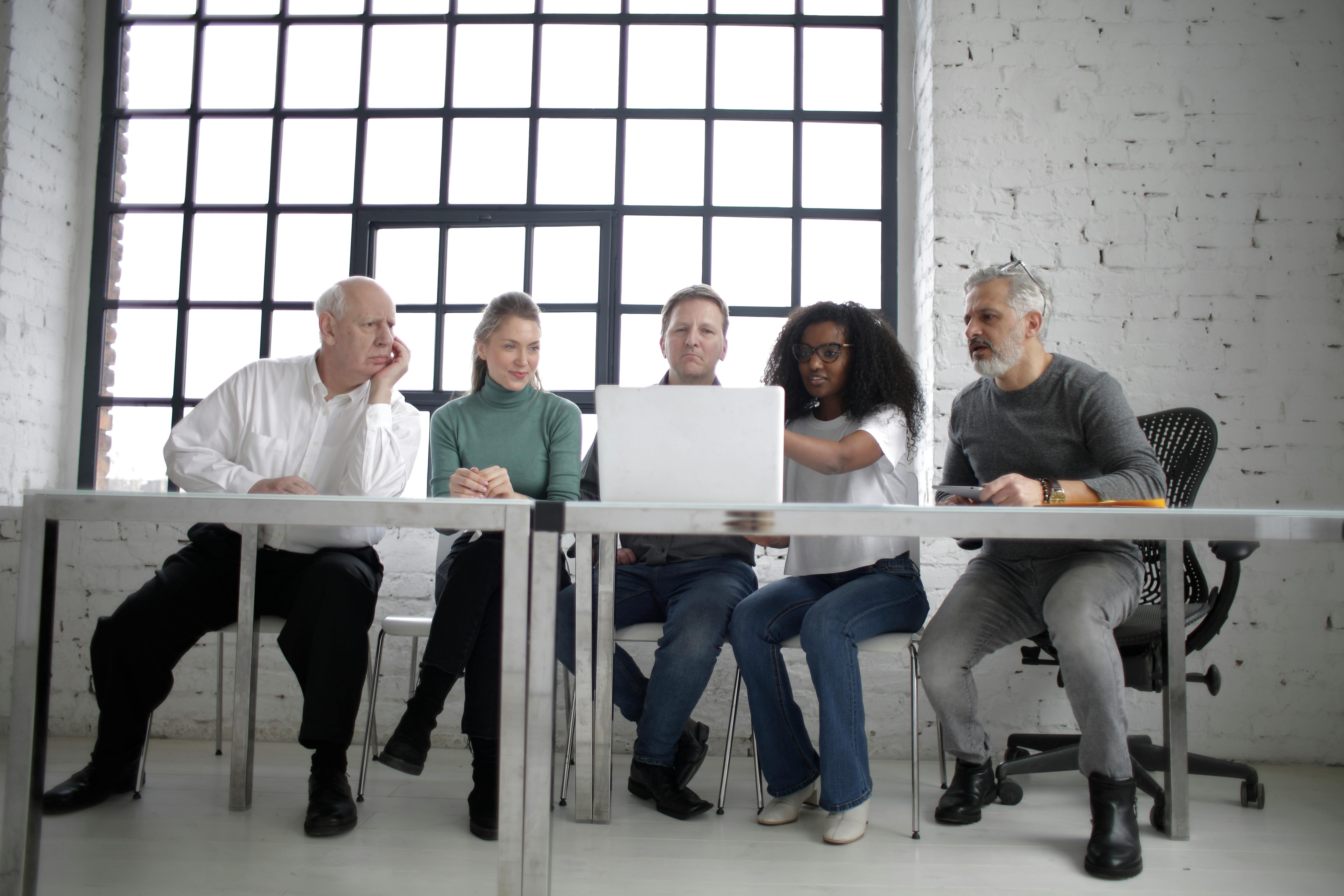 diverse team looking at a laptop