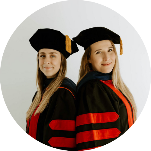 Dr. Liz and Dr. Roxy wearing PhD graduation robes
