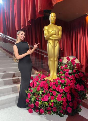 Woman pointing at tall Oscar Statue