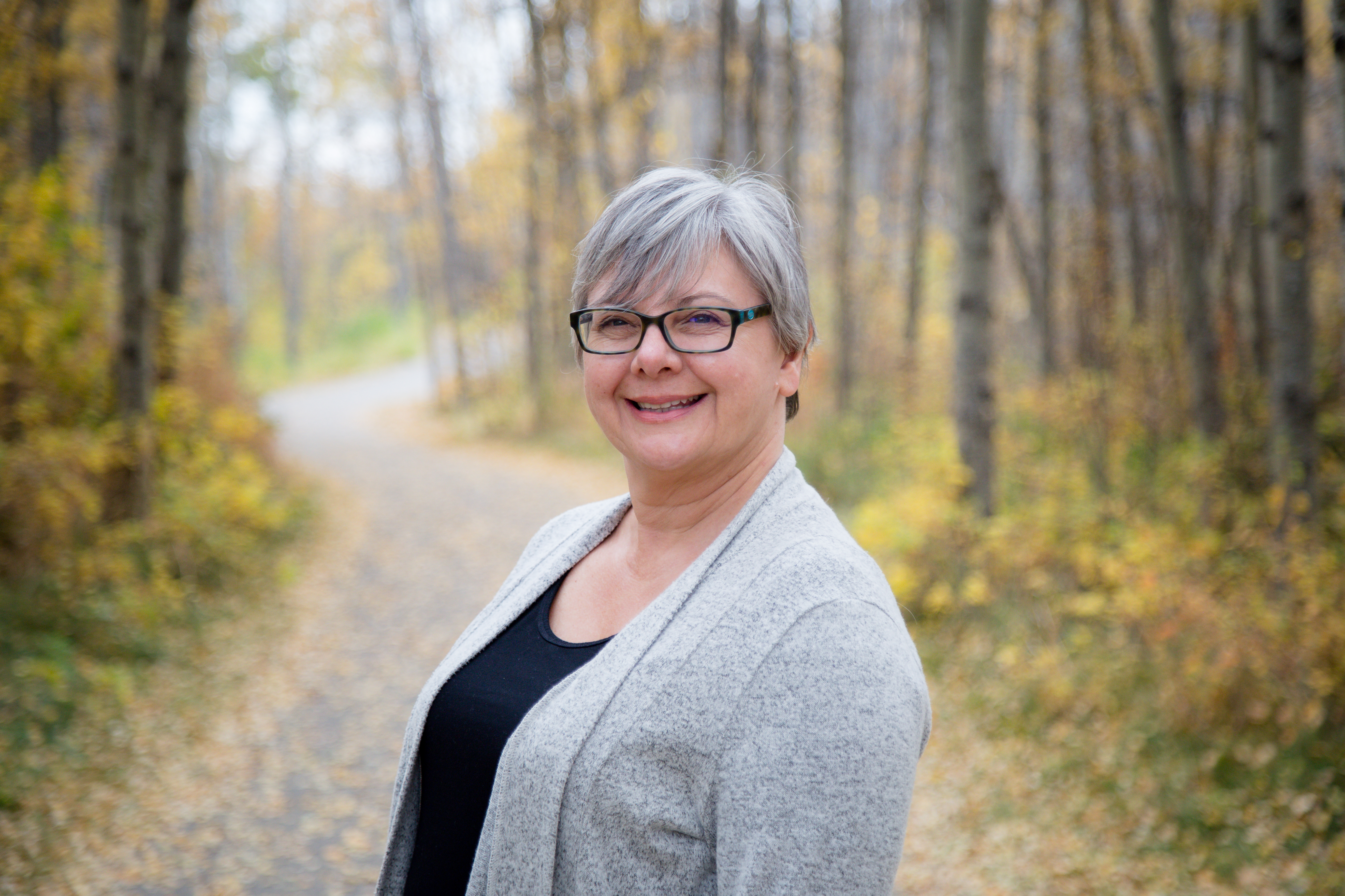 Woman smiling on path in forest