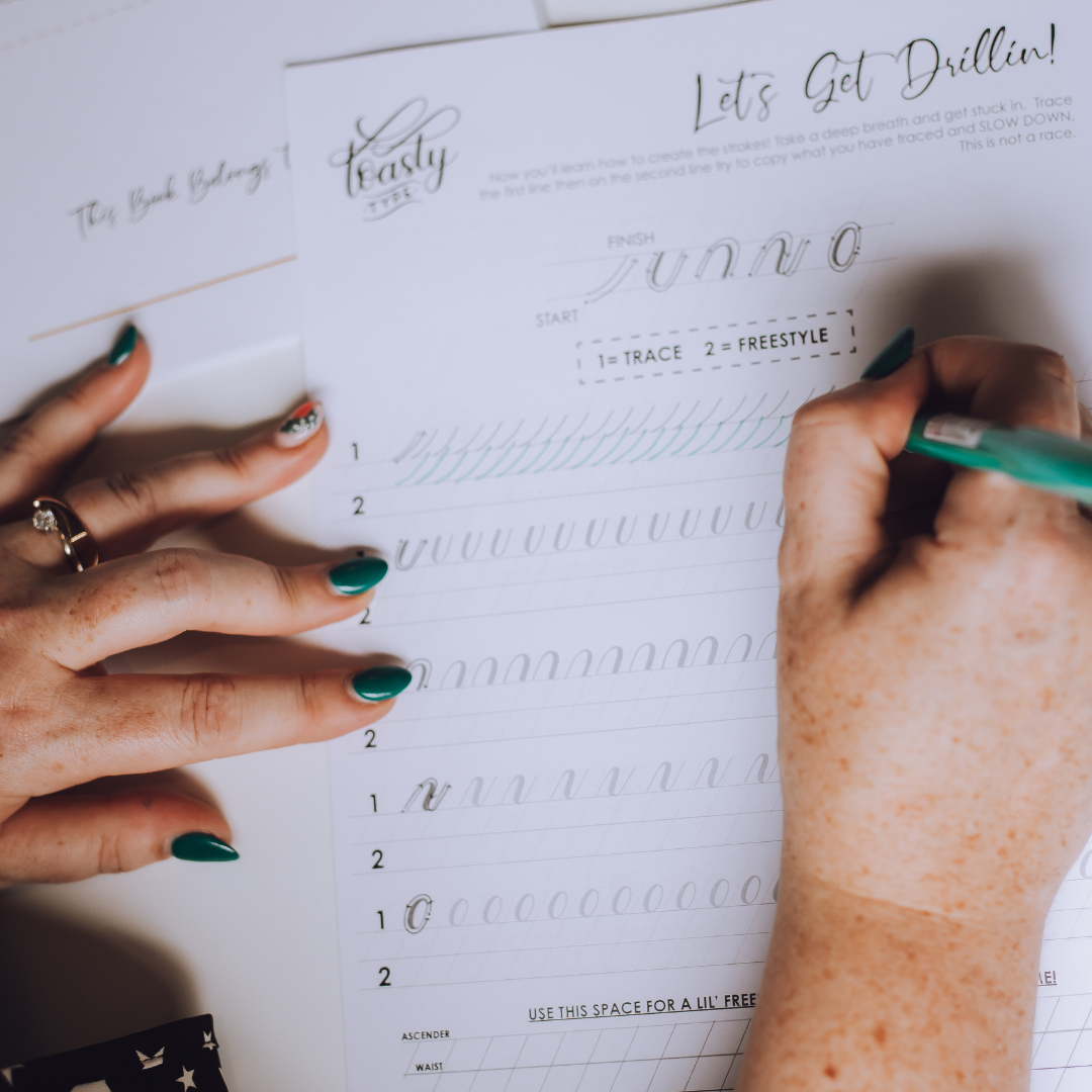 hands writing modern calligraphy