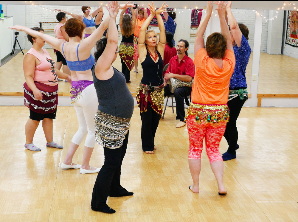 Jensuya and drummer Bob teaching belly dance to group of students at Morgan Arts Council dance studio