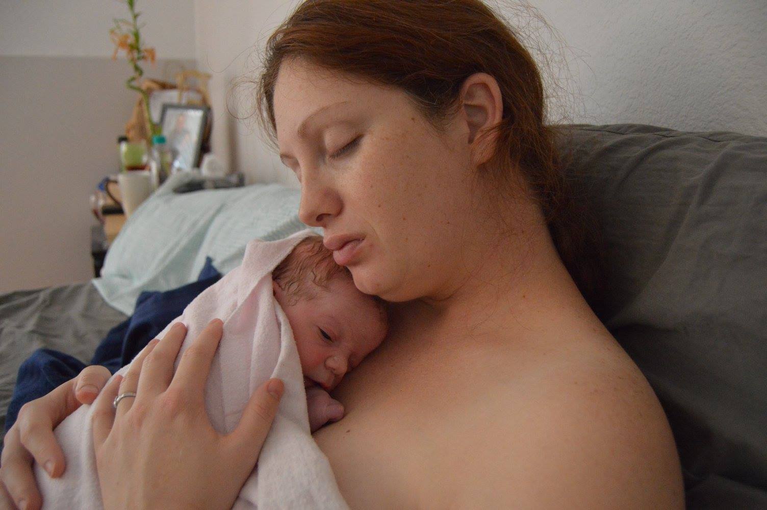 Mother snuggles baby after VBAC