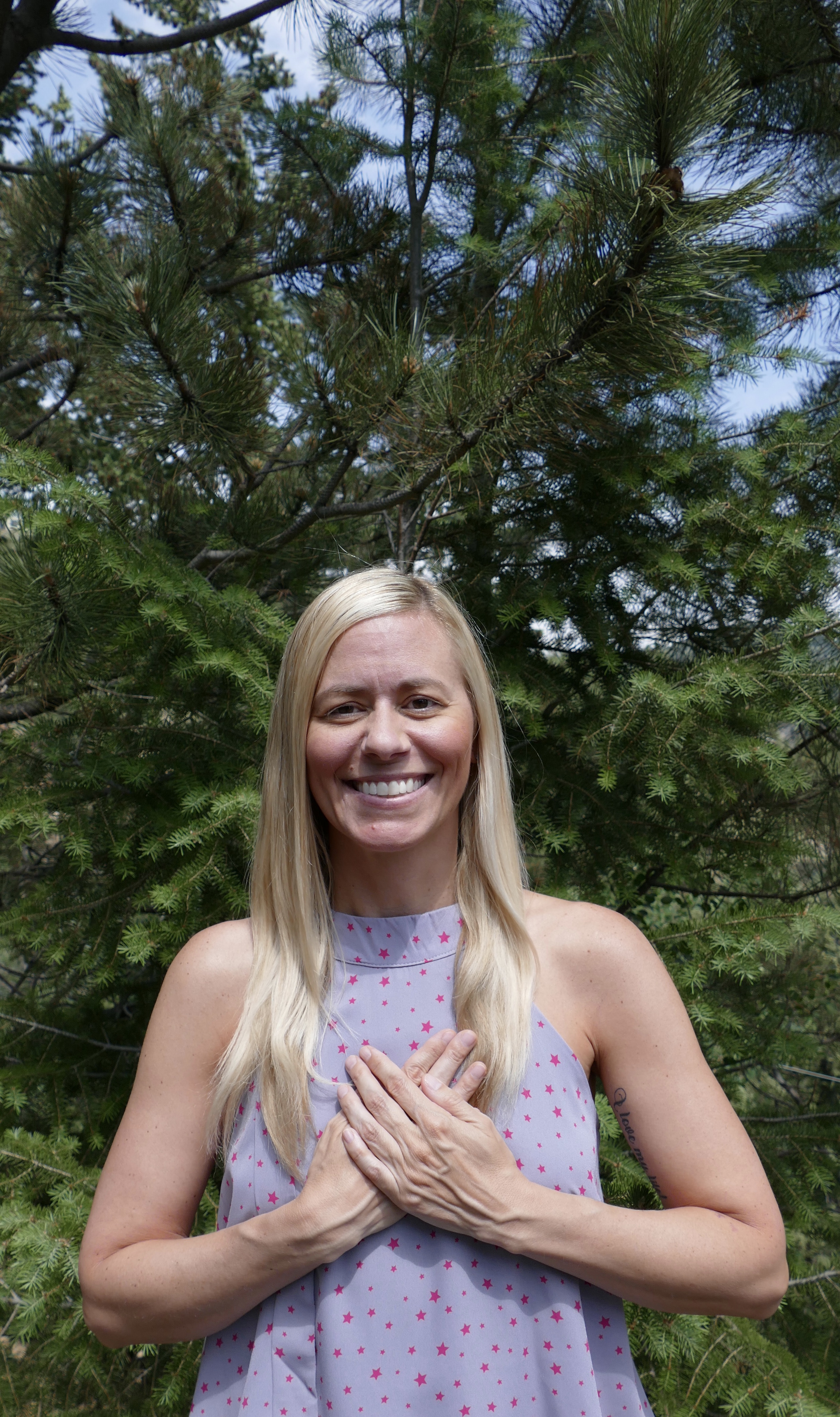 woman posing in front of a tree