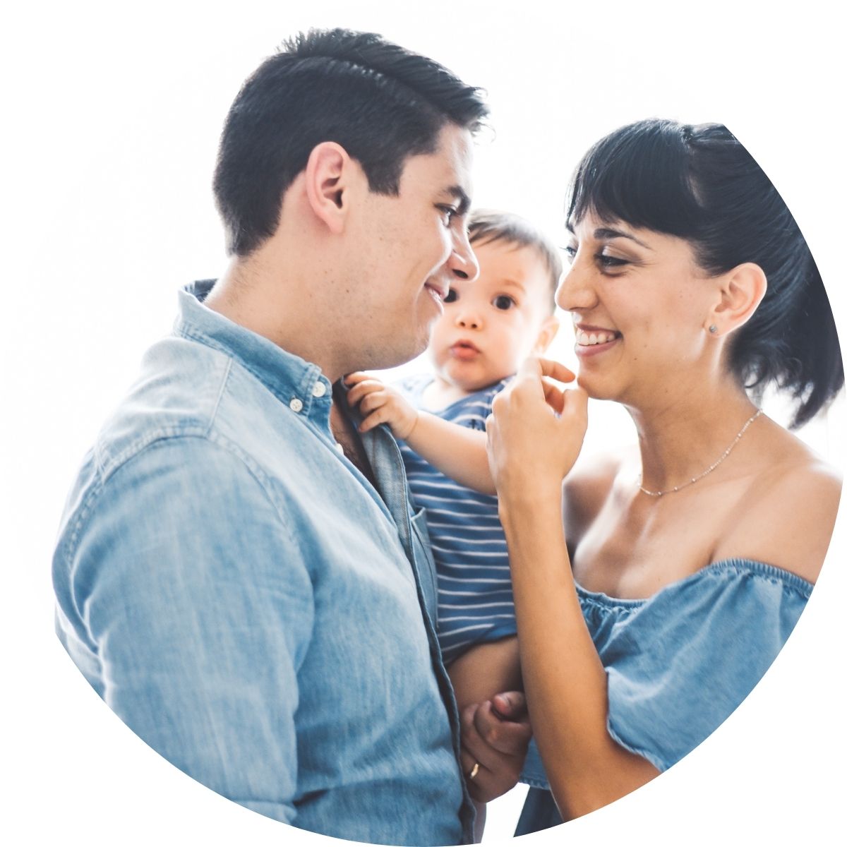 Couple laughing and smiling while holding a baby between them