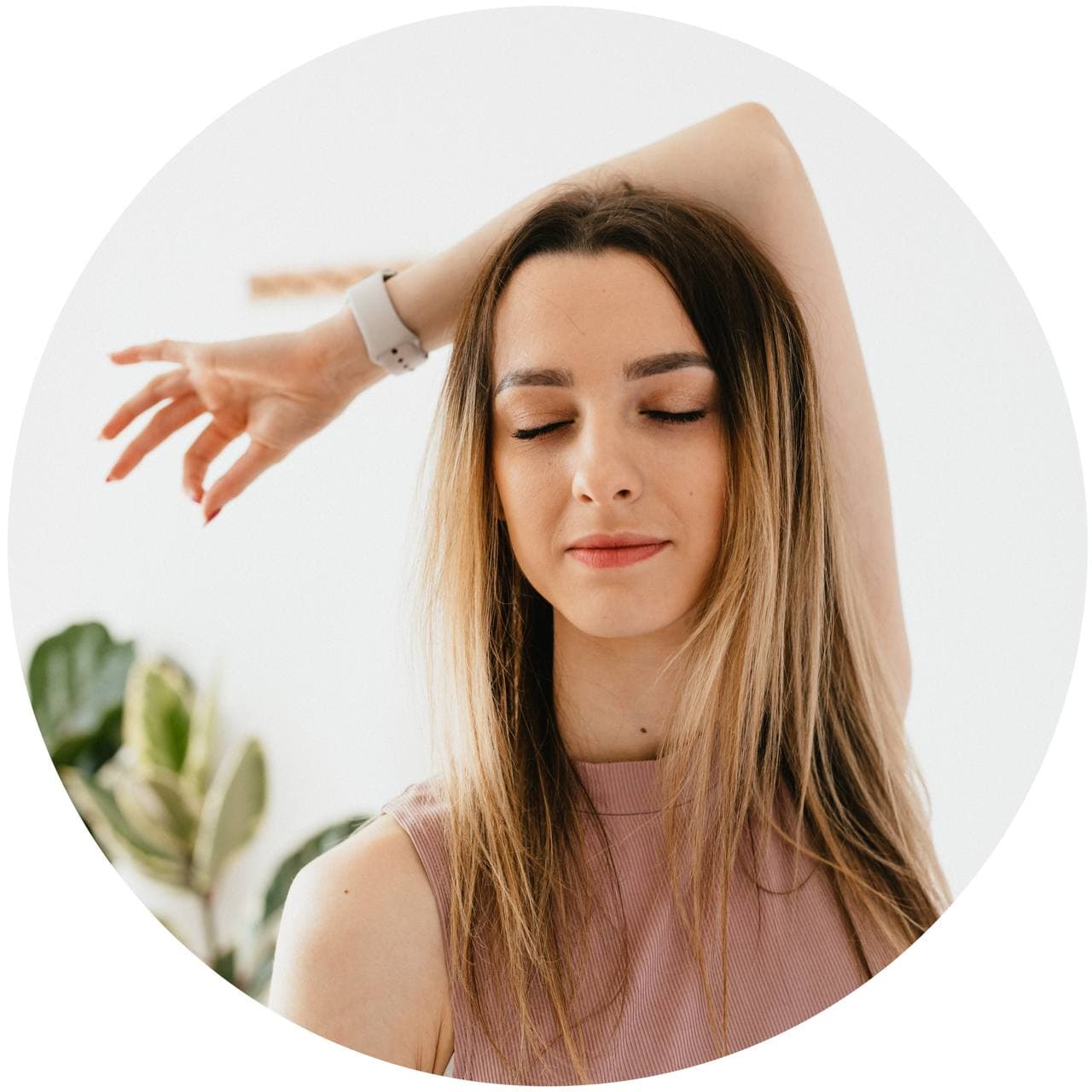 Girl meditating with her eyes closed and one hand behind her head