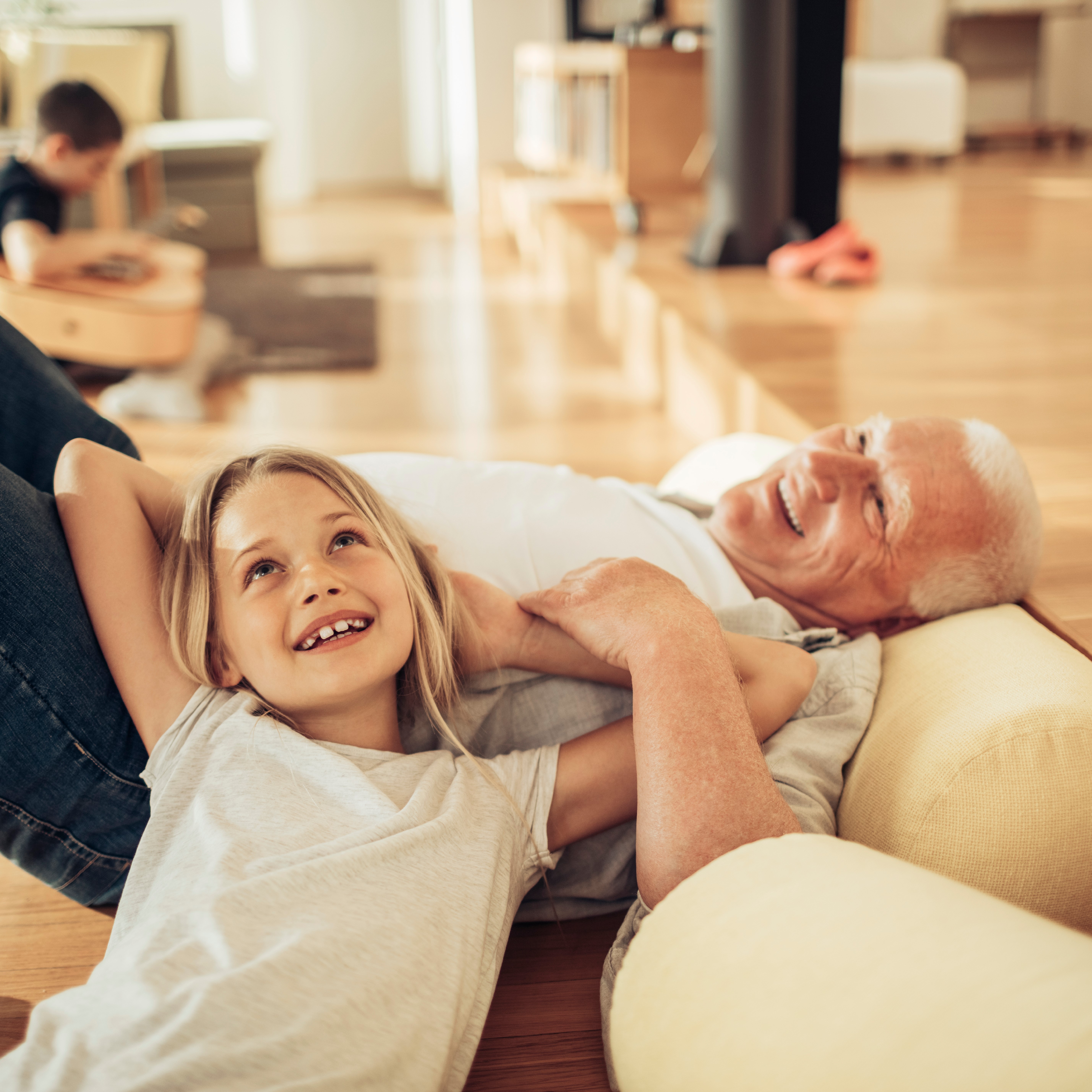 Grandpa and granddaughter on sofa